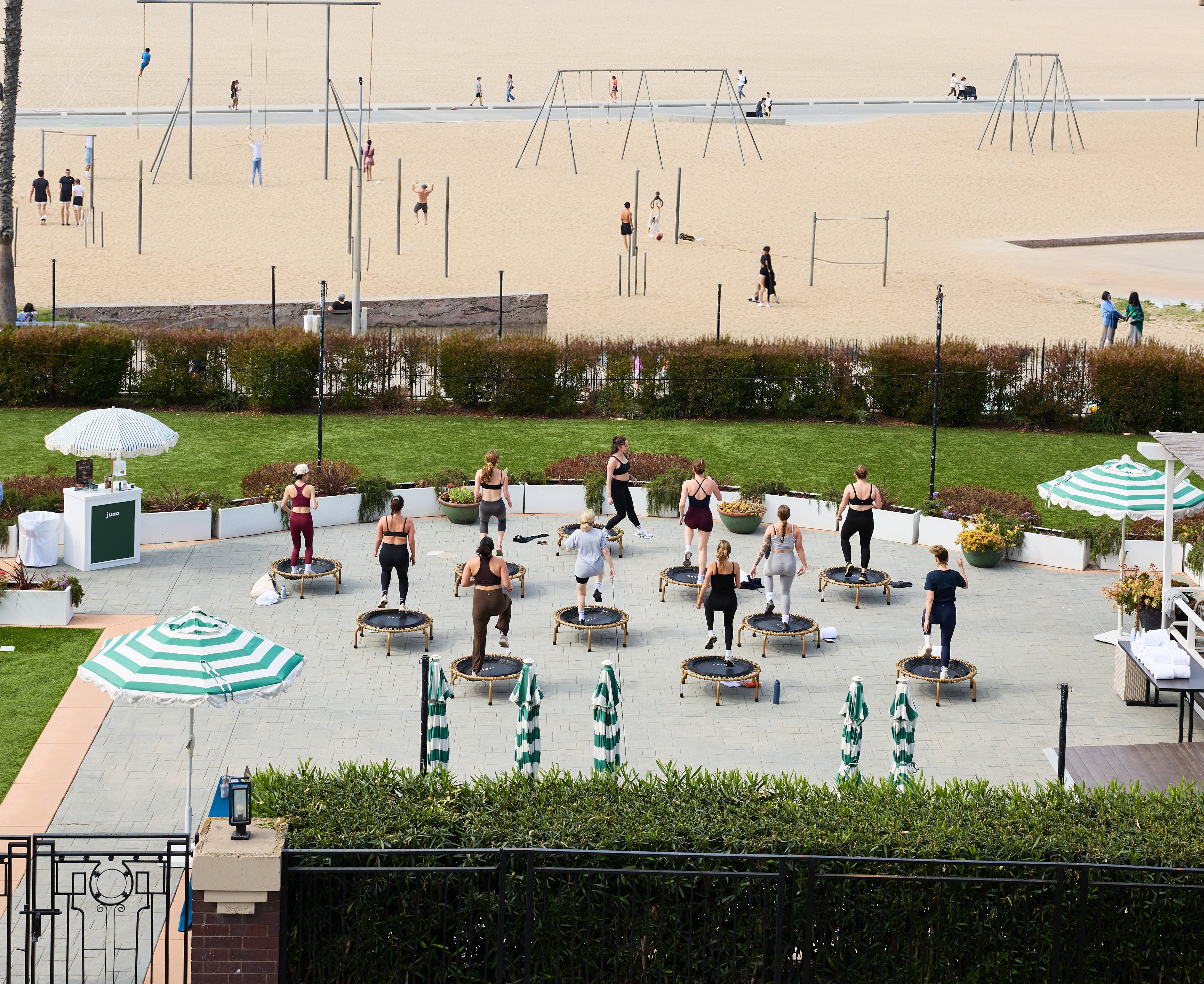The Ness trampoline fitness class set up at Regent Santa Monica Beach with rebounders overlooking the ocean