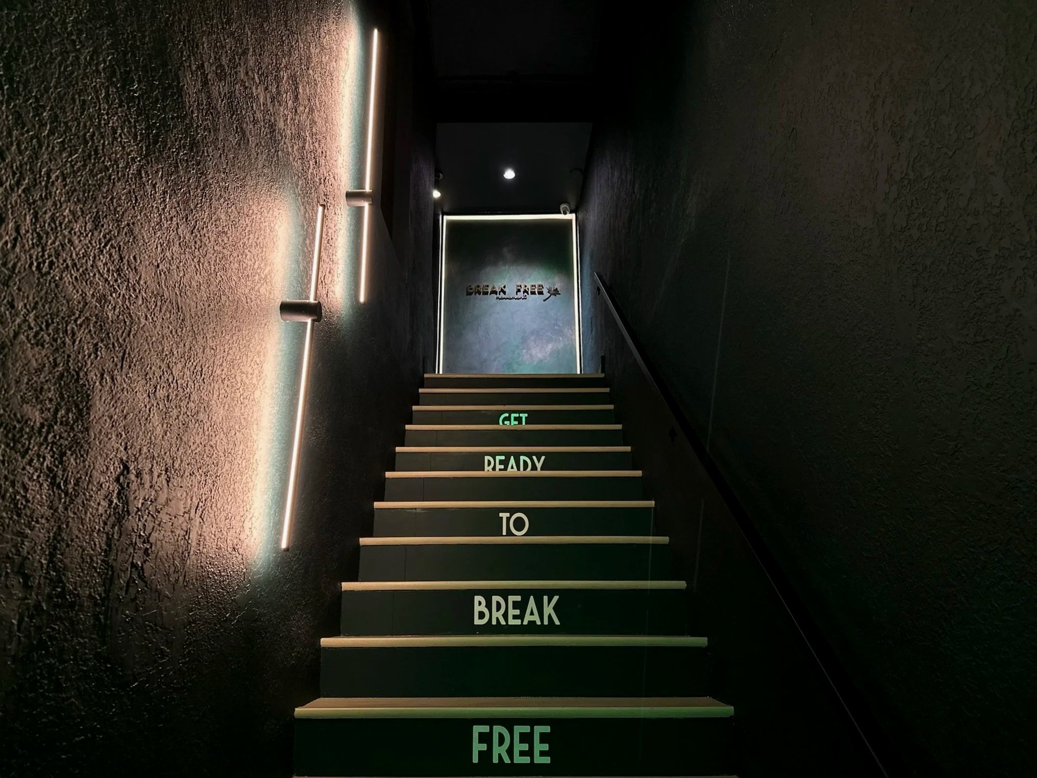 Illuminated entrance stairs leading up to Break Free Movement in Coral Gables