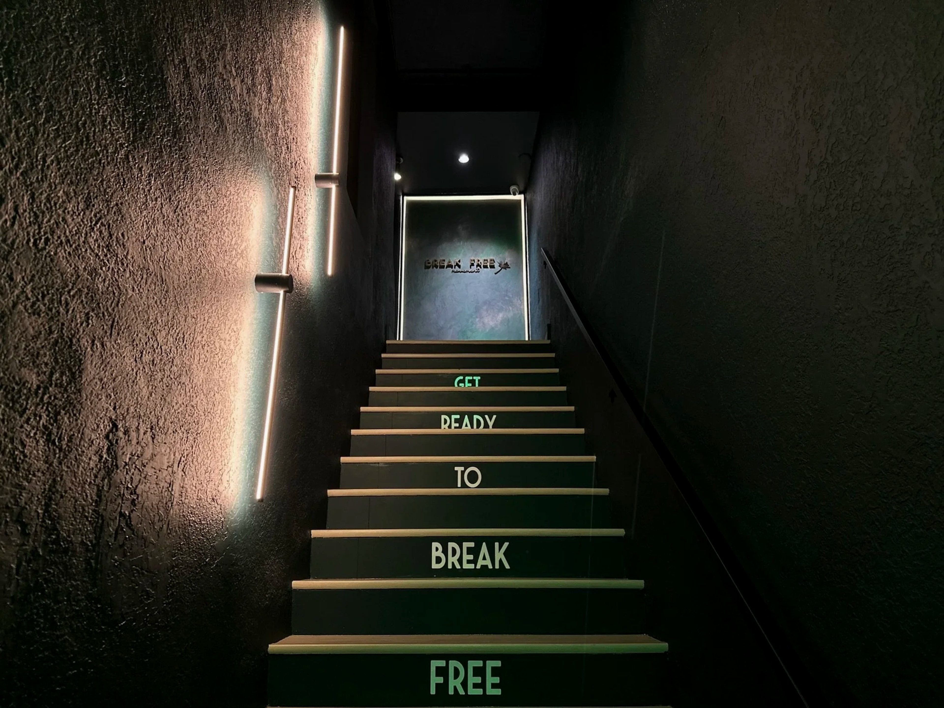 Illuminated entrance stairs leading up to Break Free Movement in Coral Gables
