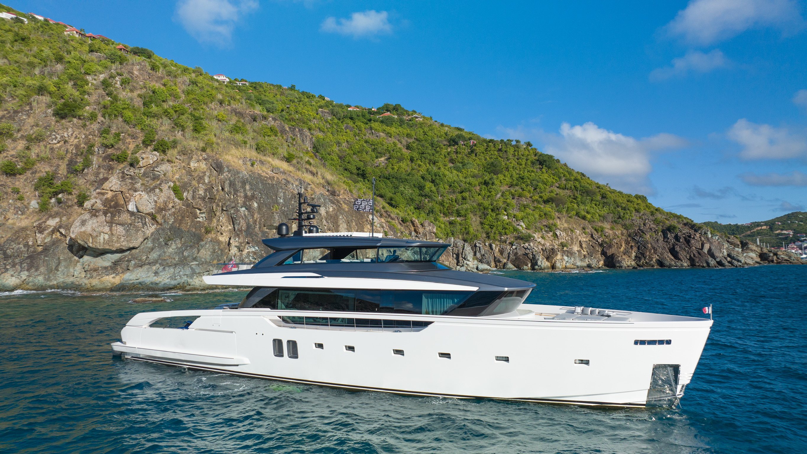 Aerial view of the yacht's bow and deck on turquoise water