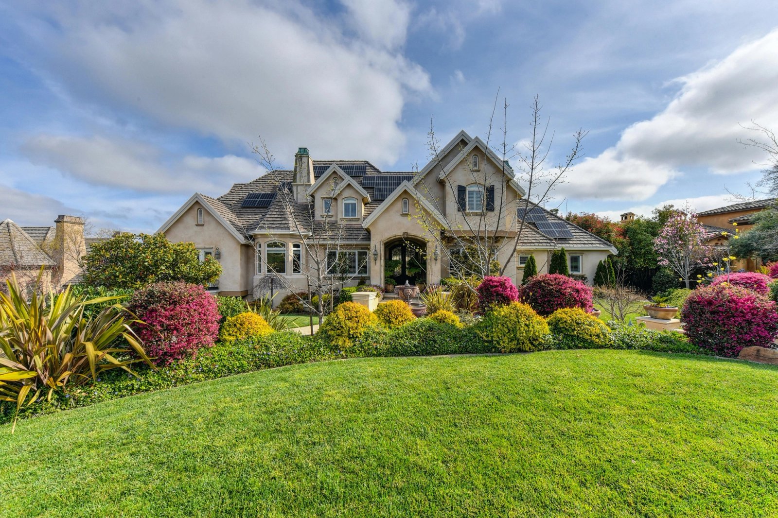Front of the house with lawn and garden bed