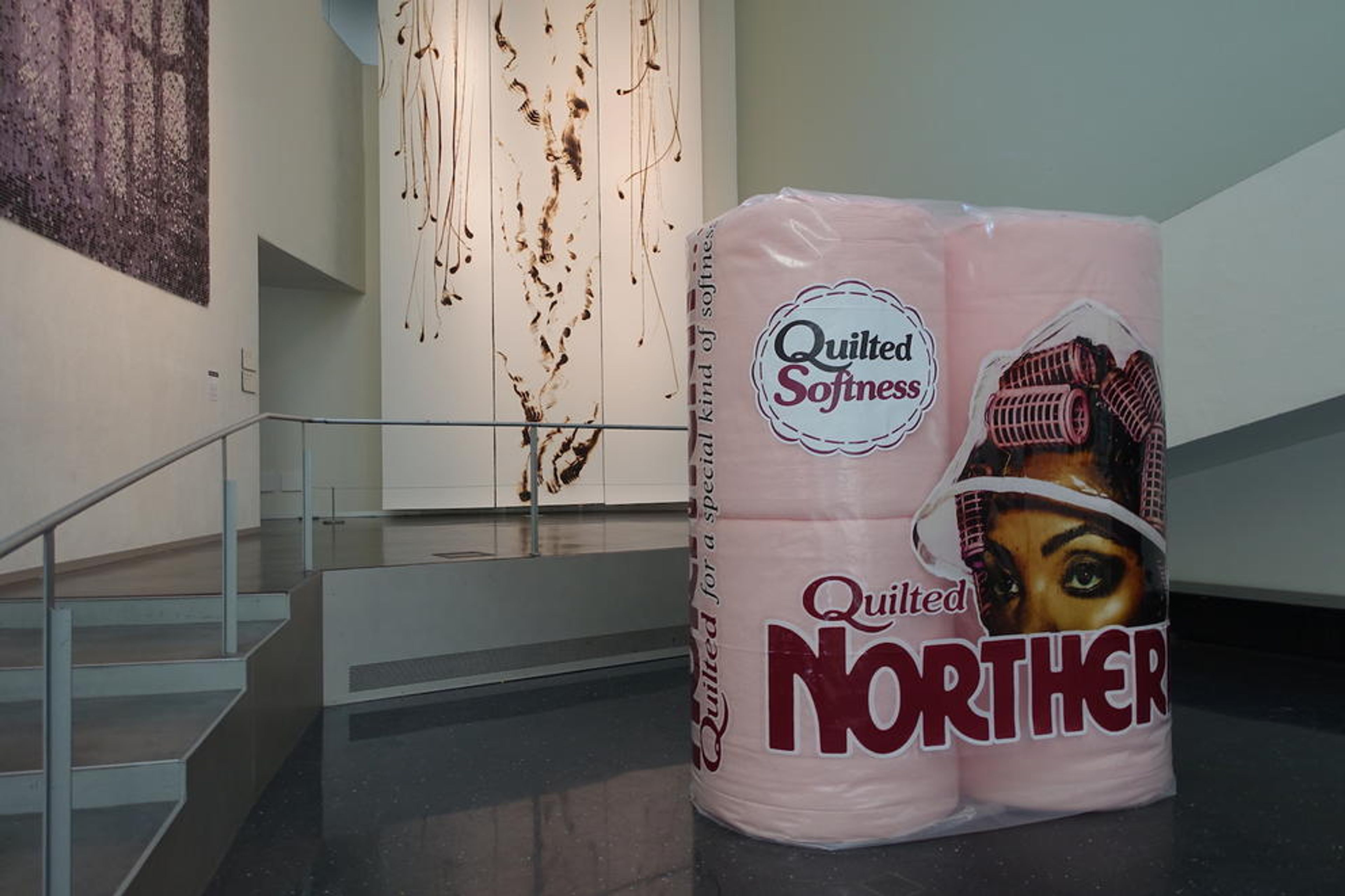 extra large version of four pink toilet rolls called "Quilted Northern" 