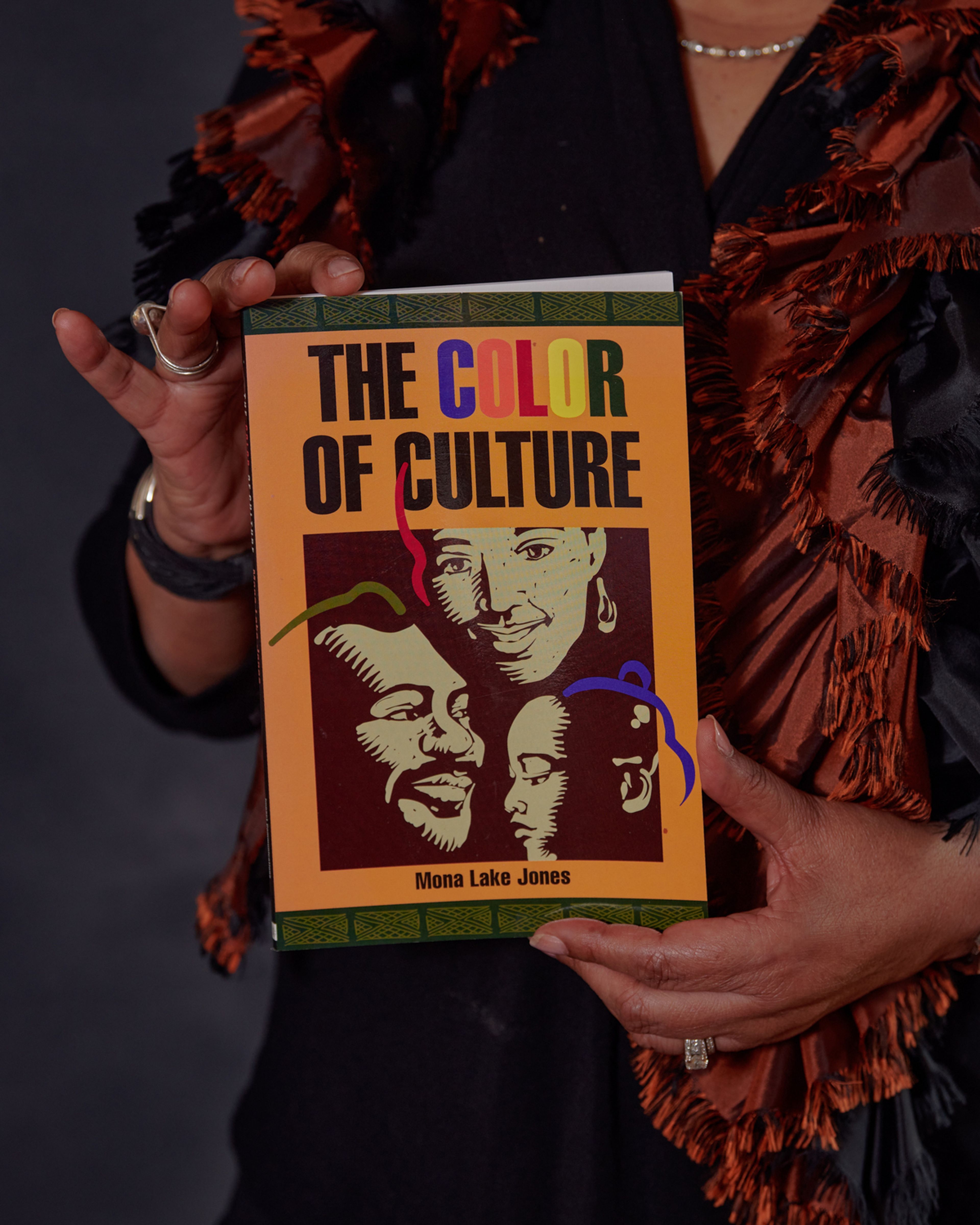 Person holding book The Color of Culture