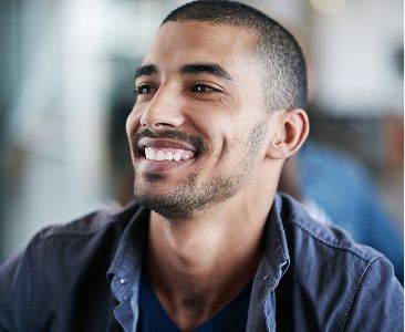 A smiling man looking to the side