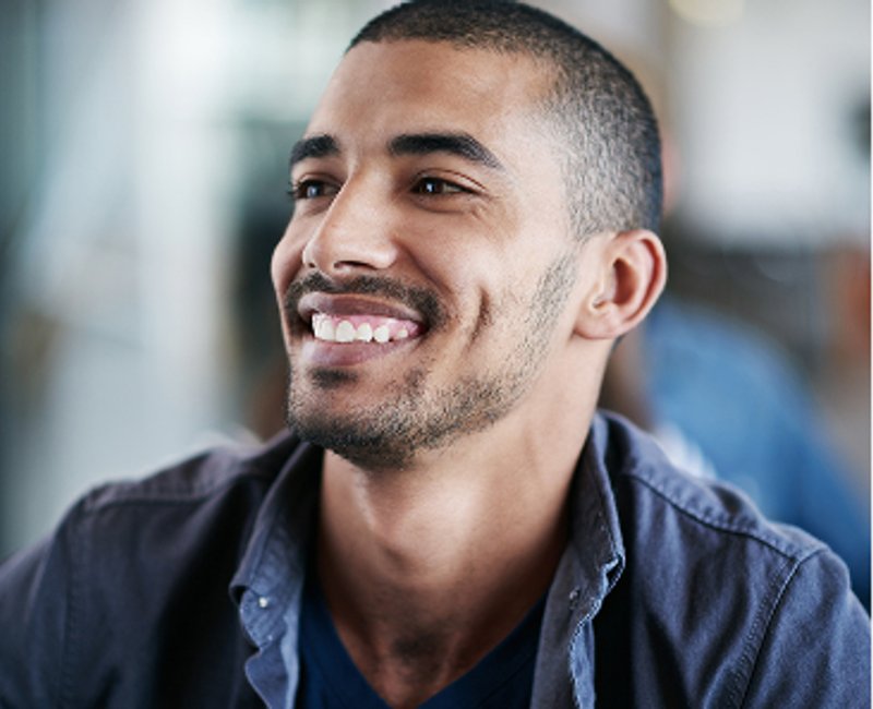 A smiling man looking to the side