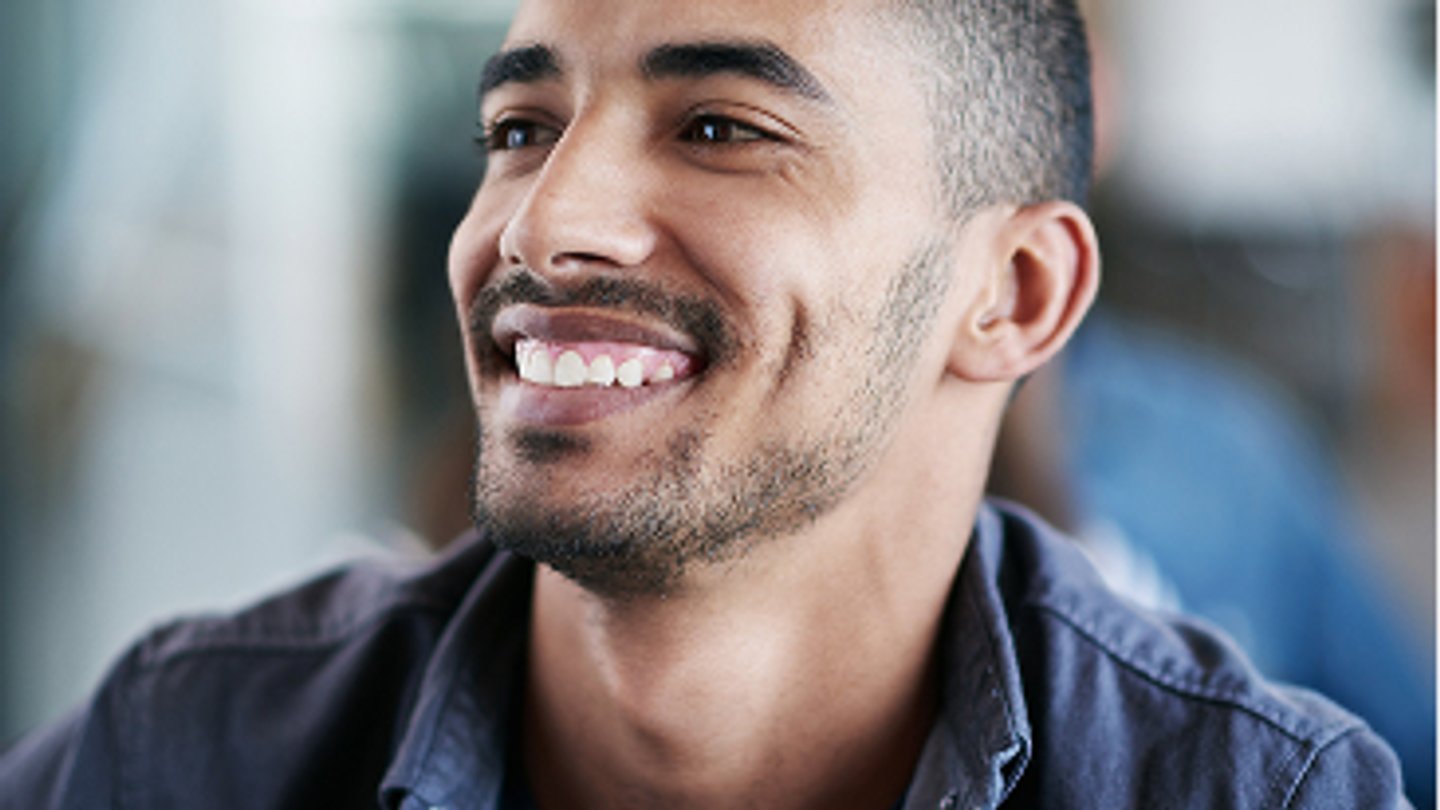 A smiling man looking to the side