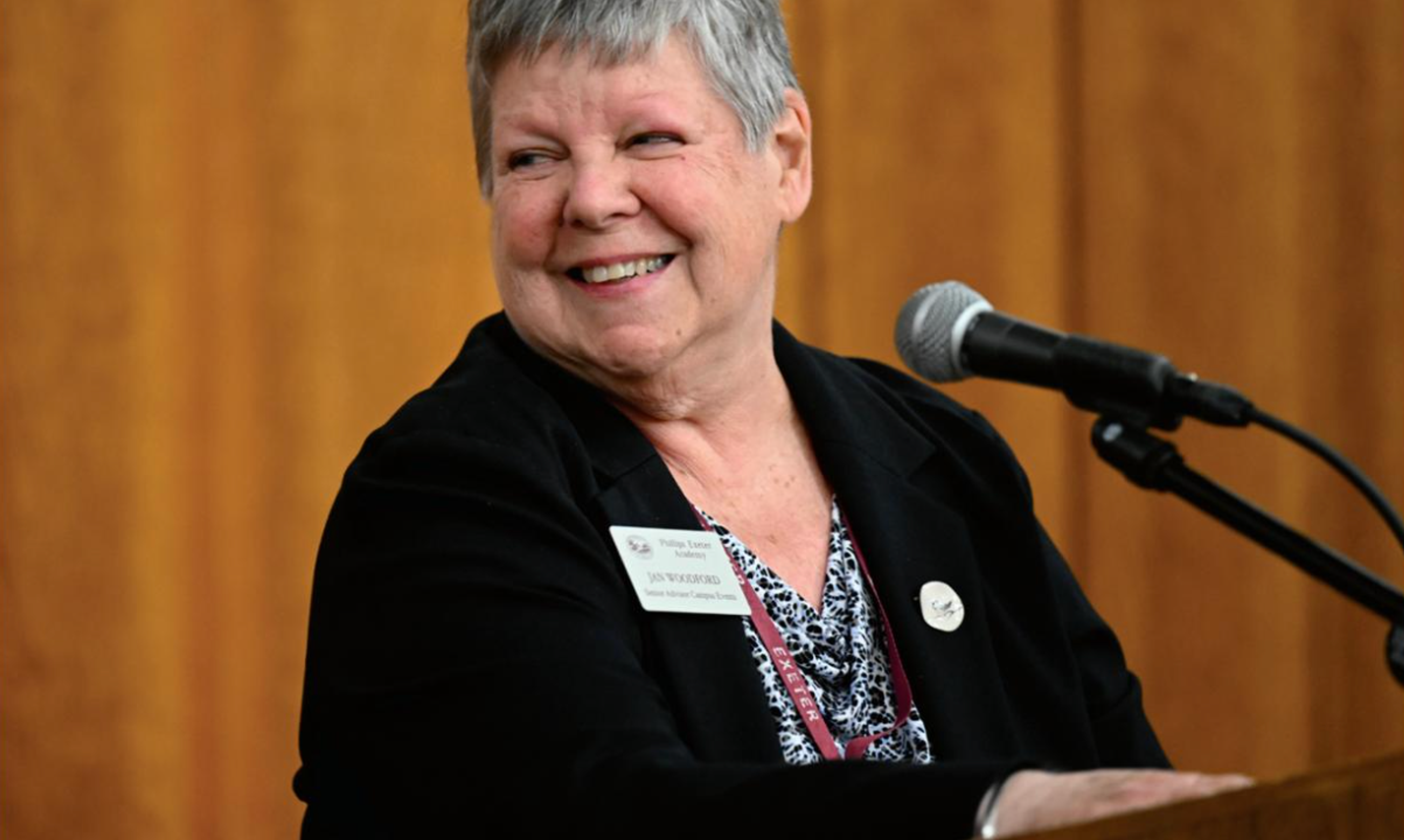 woman smiling at a podium