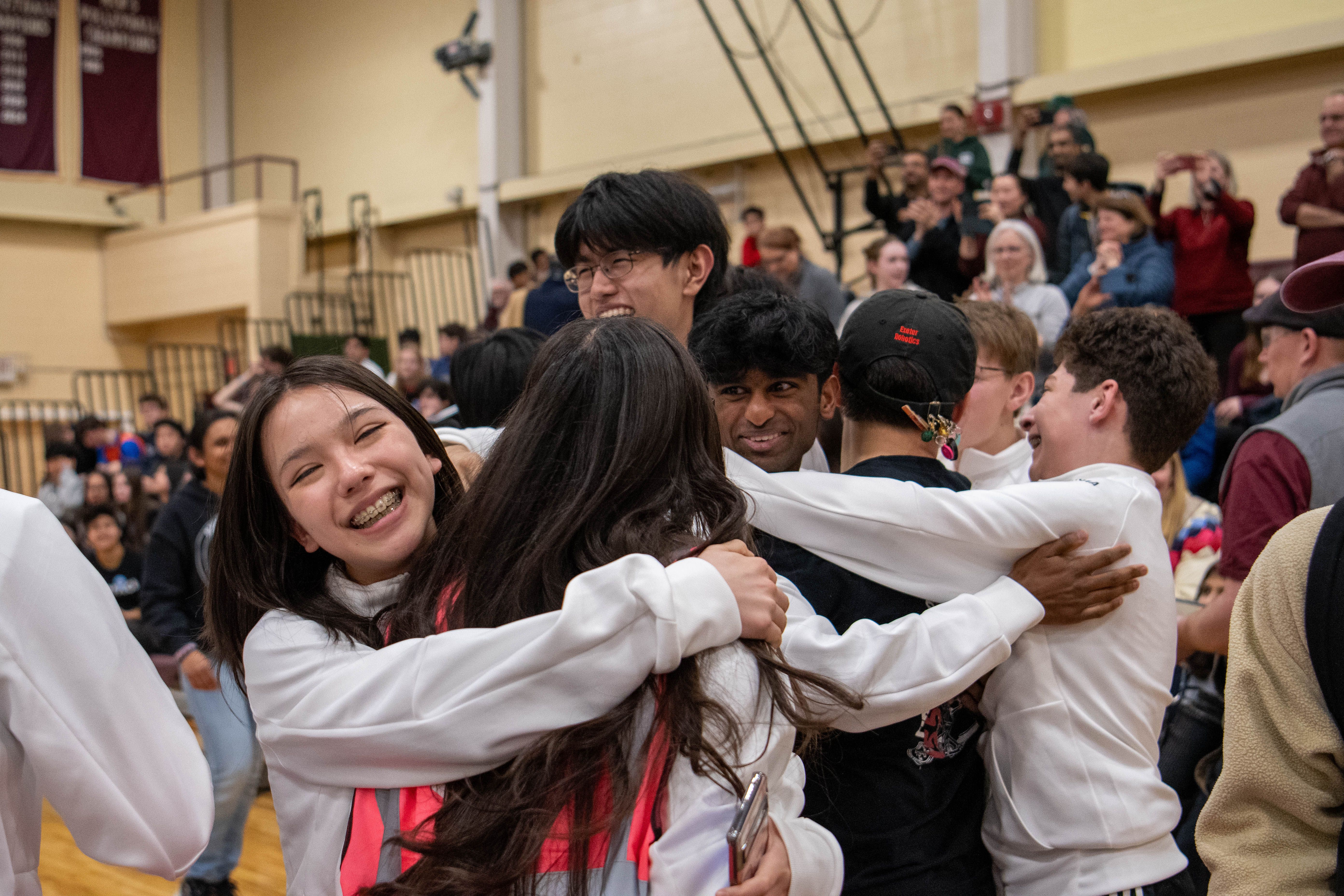 students embrace in celebration.