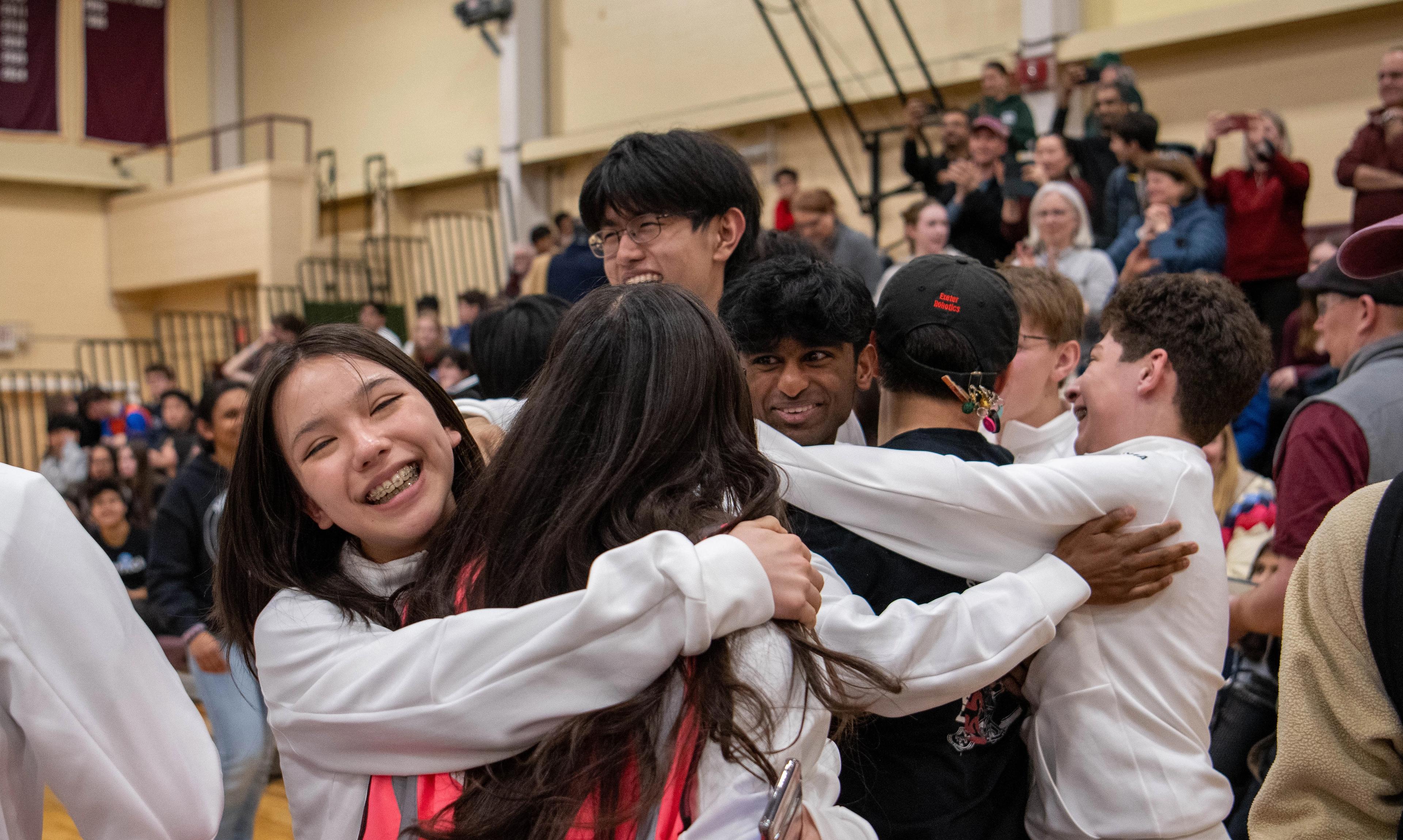 students embrace in celebration.