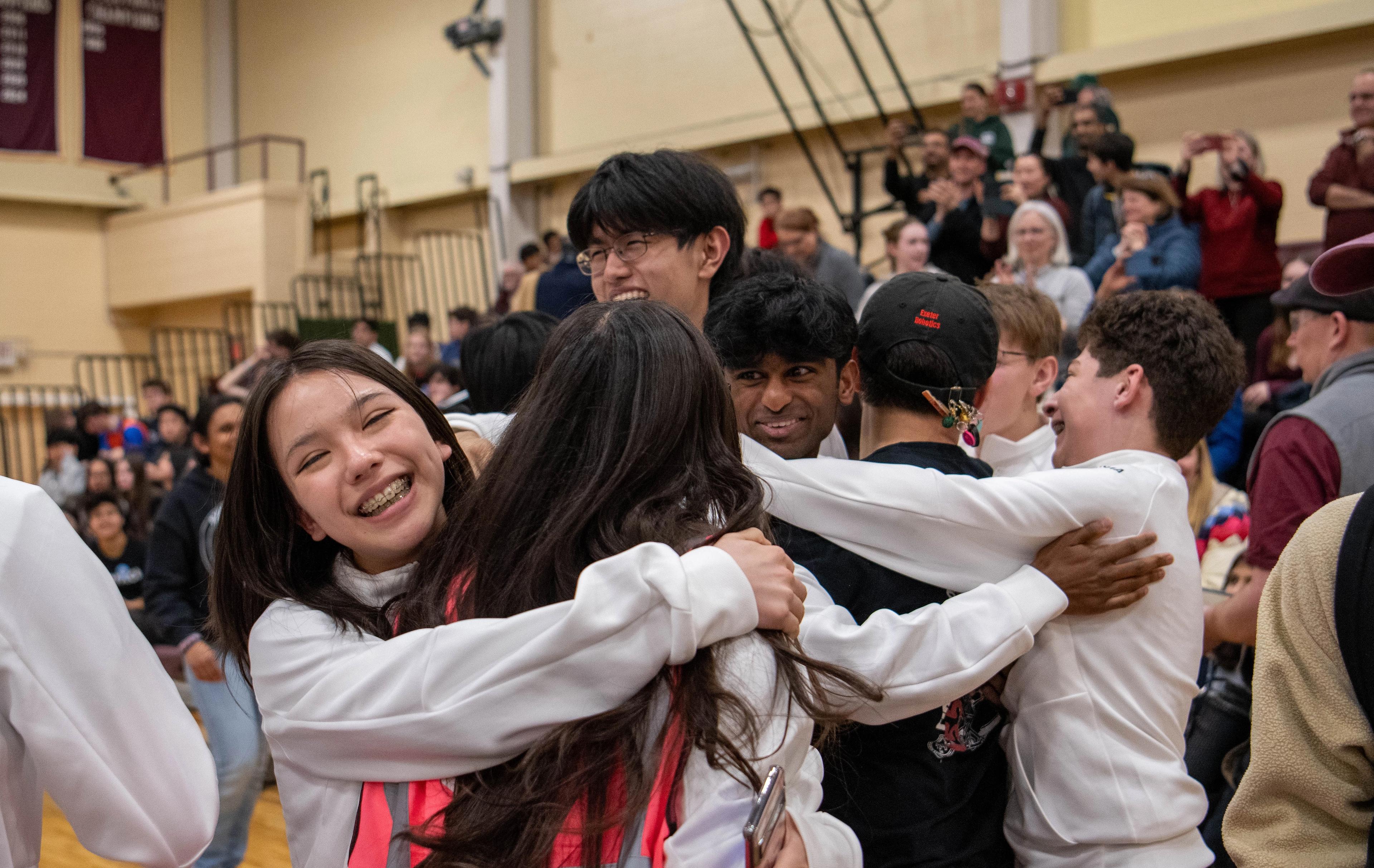 students embrace in celebration.