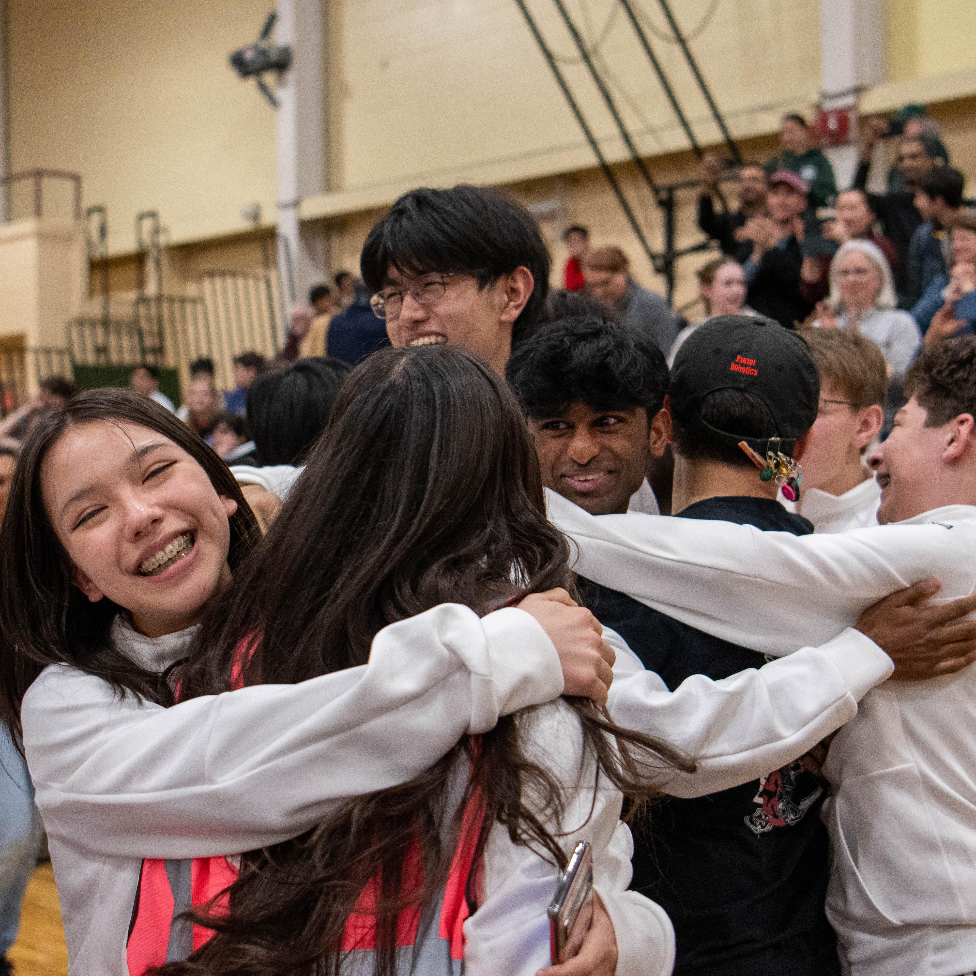 students embrace in celebration.