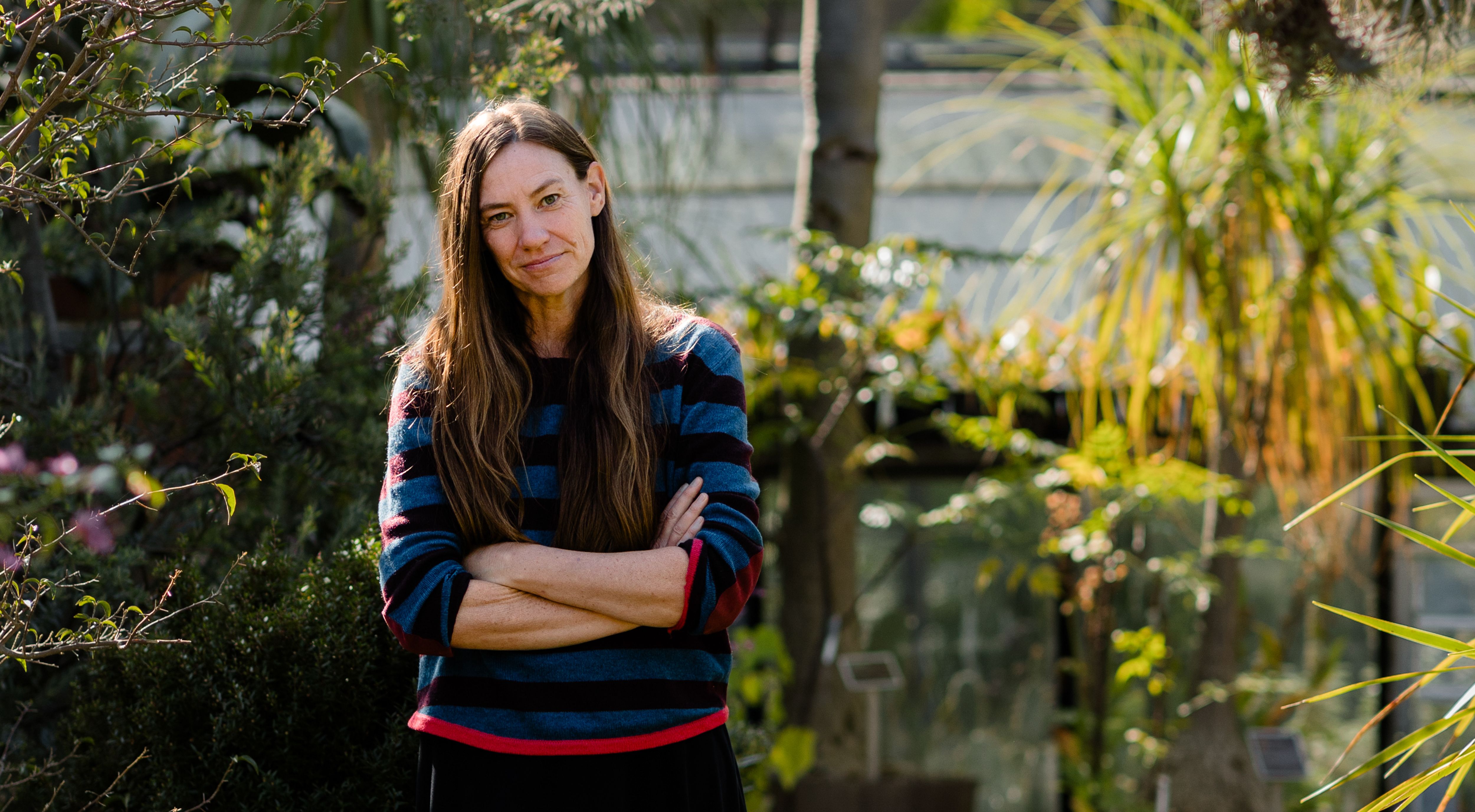scientist stands among flora.