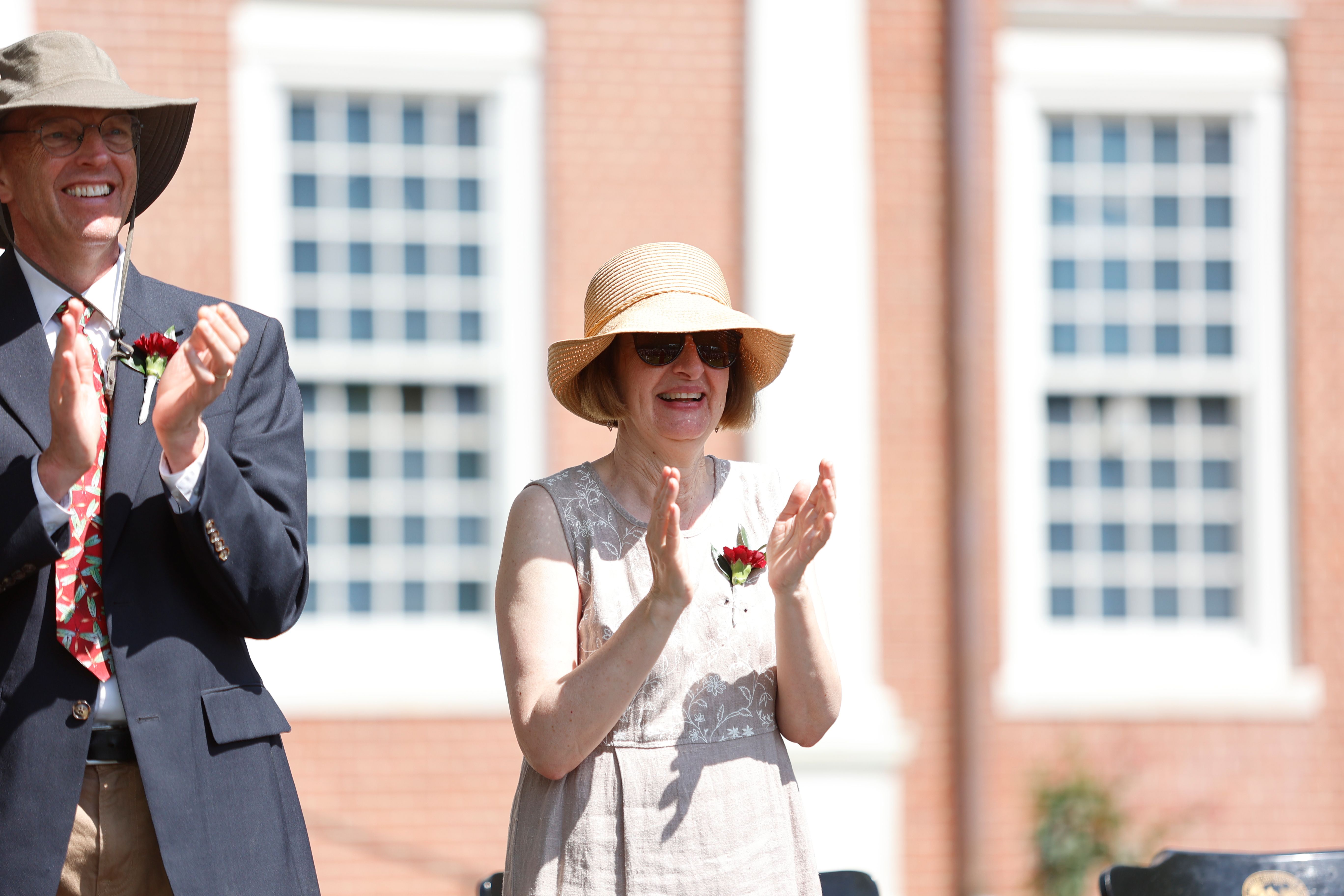 A teacher applauds a speech.