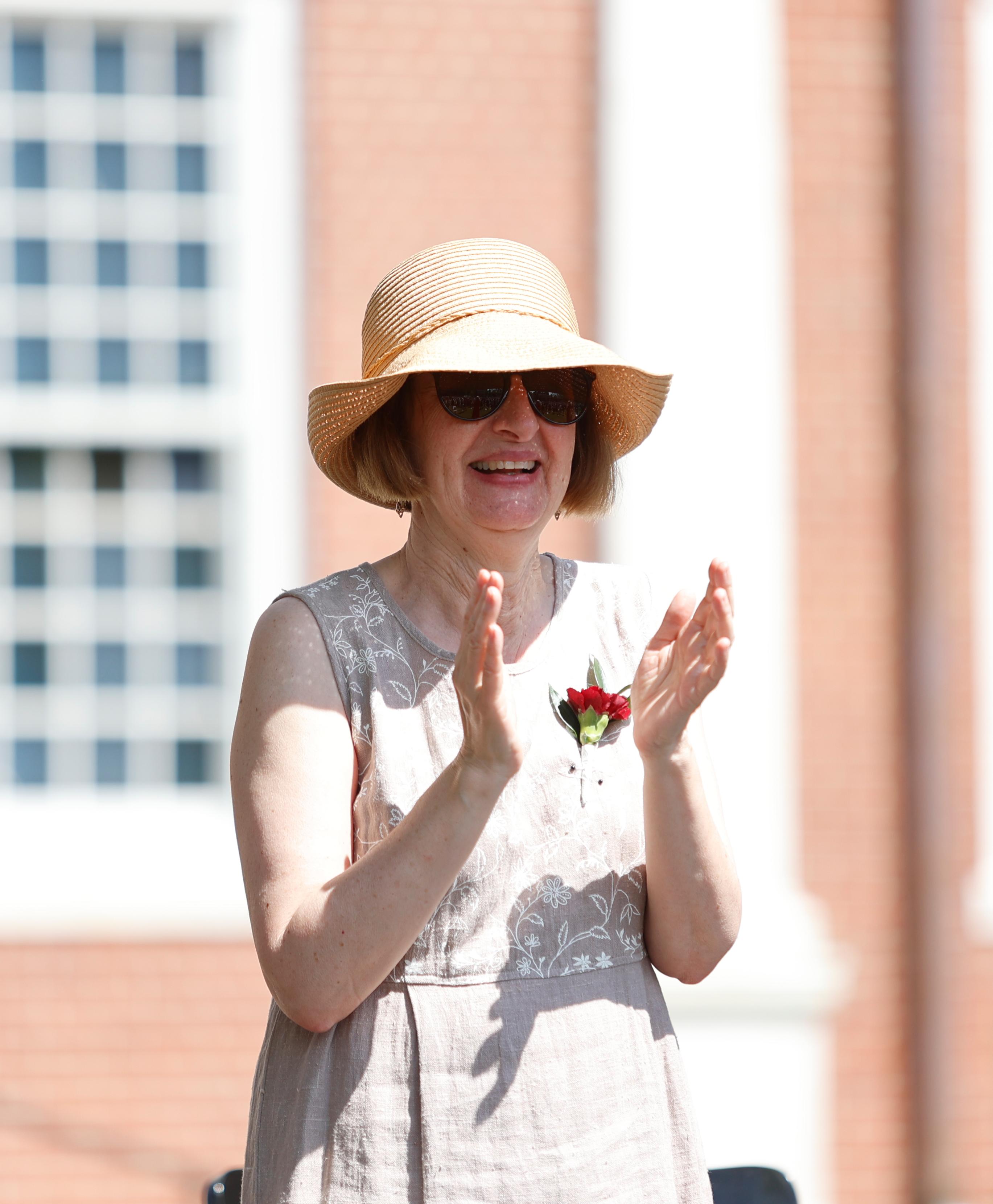 A teacher applauds a speech.