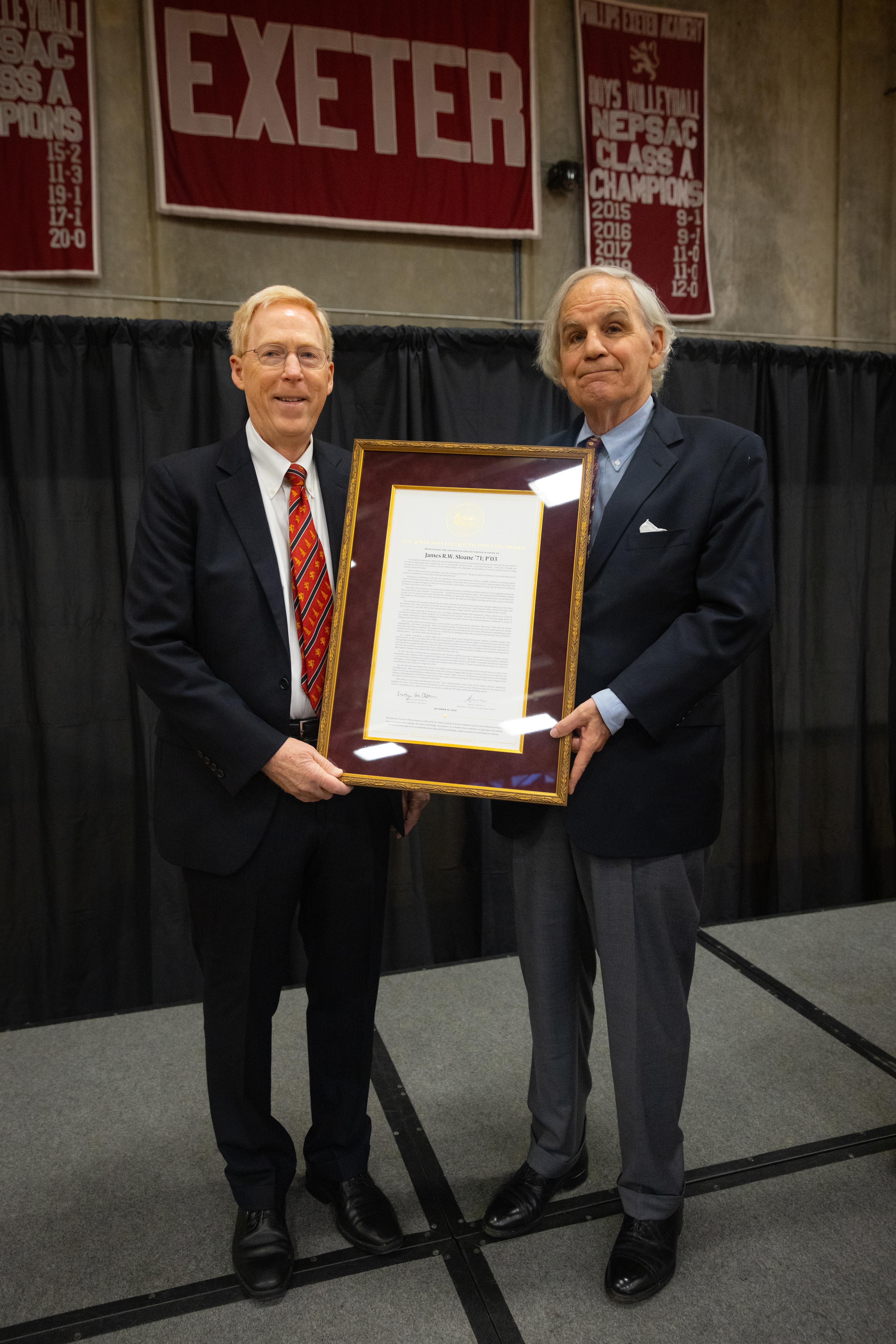 two men holding an award