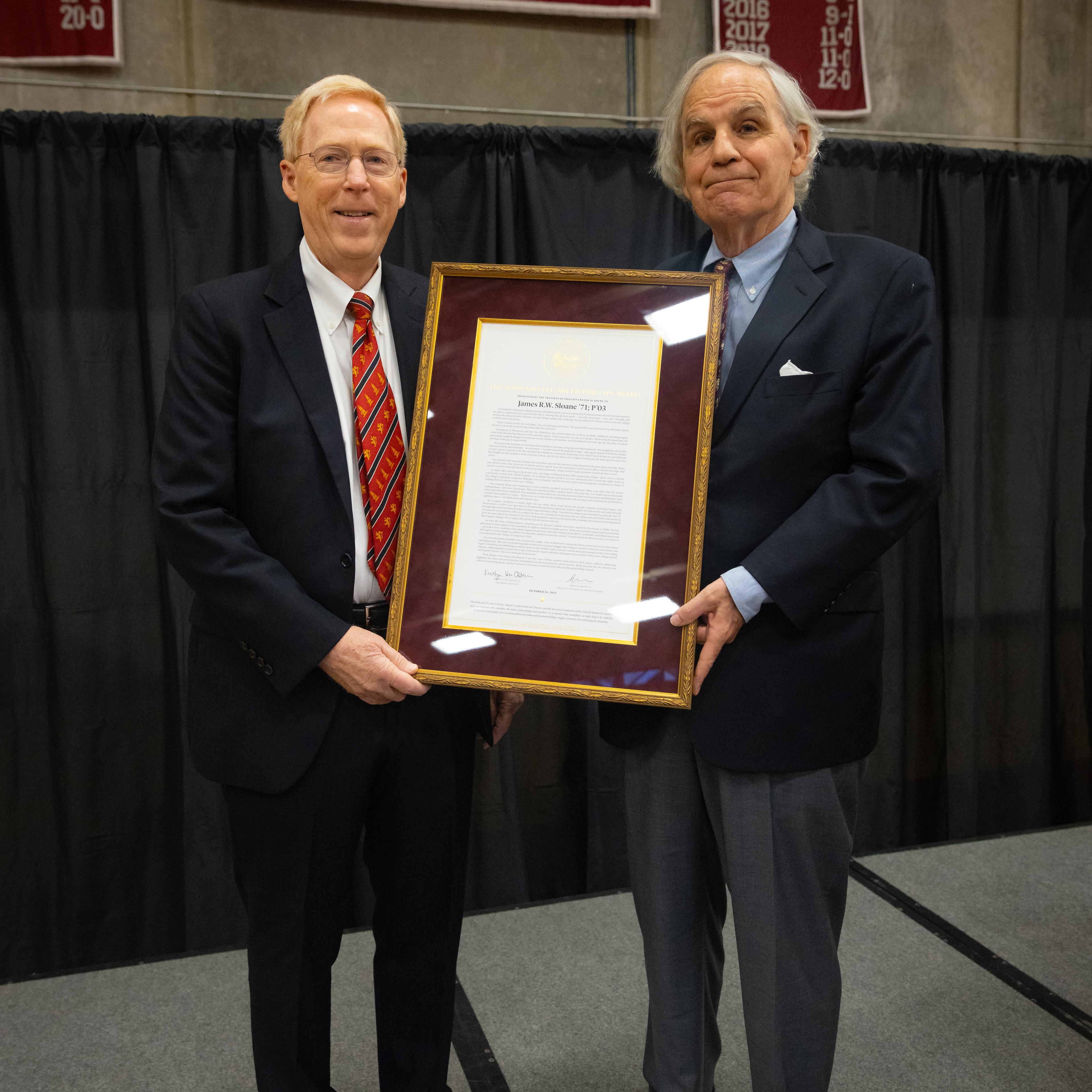 two men holding an award