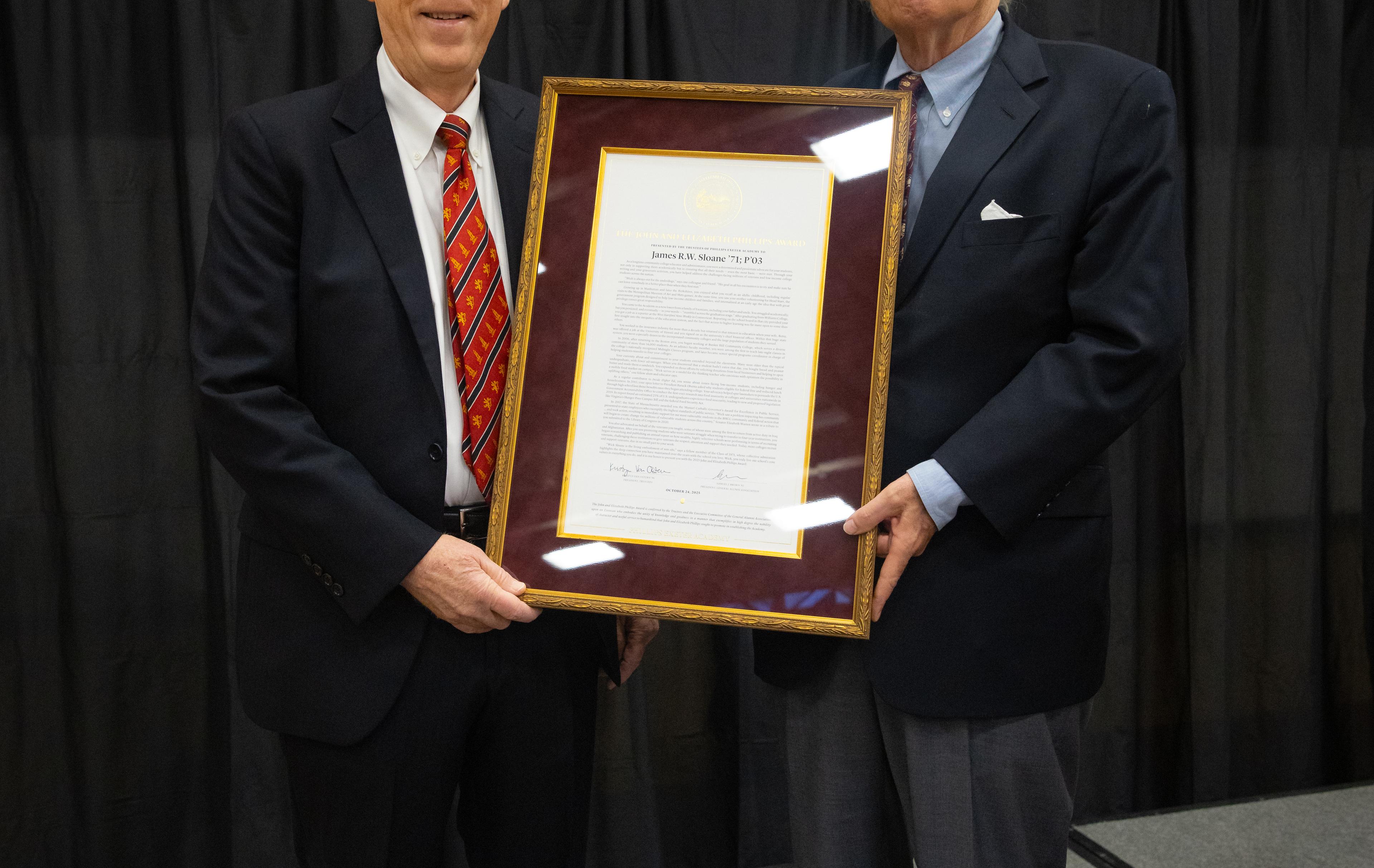two men holding an award