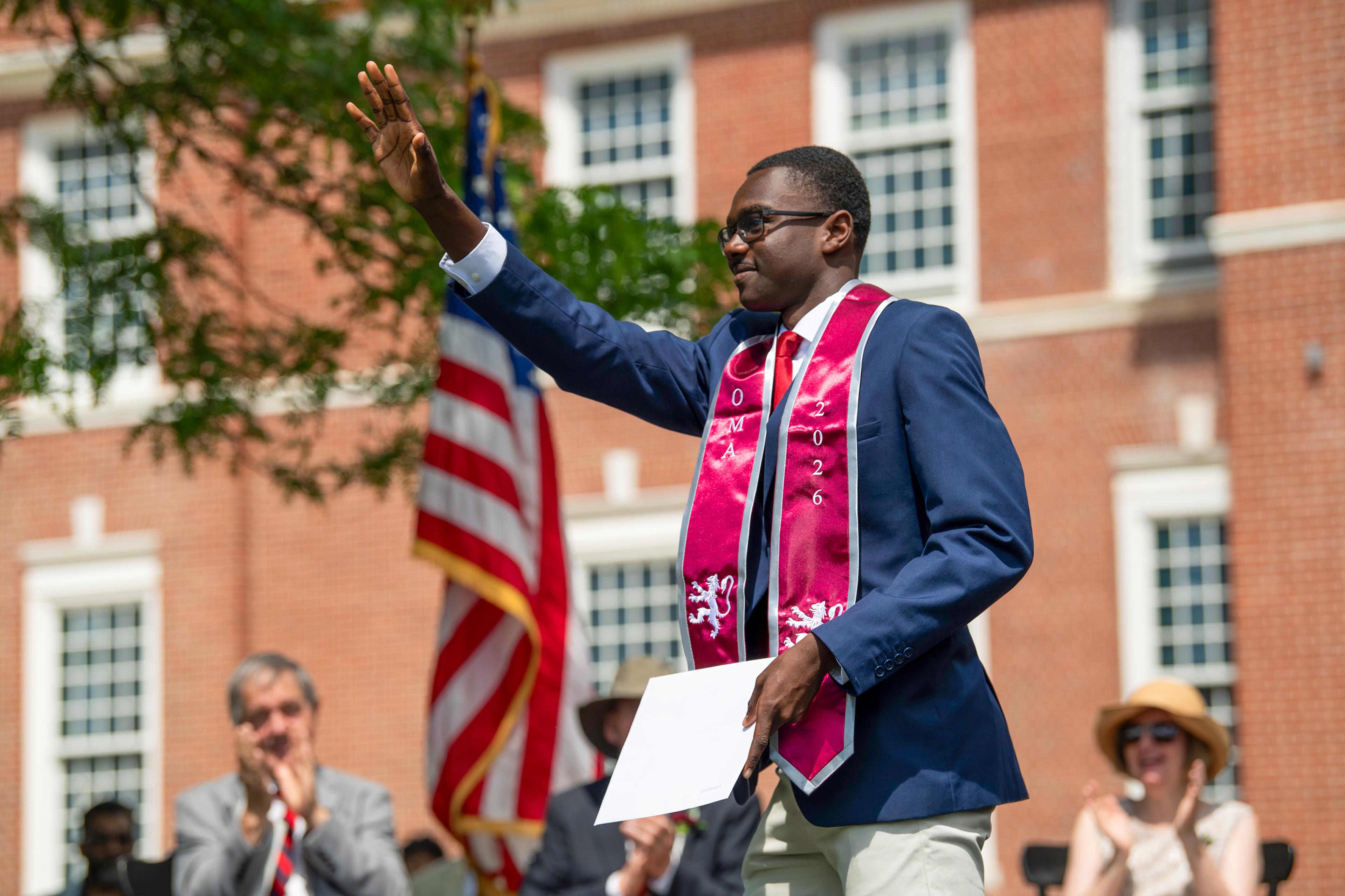 Student walks across graduation stage