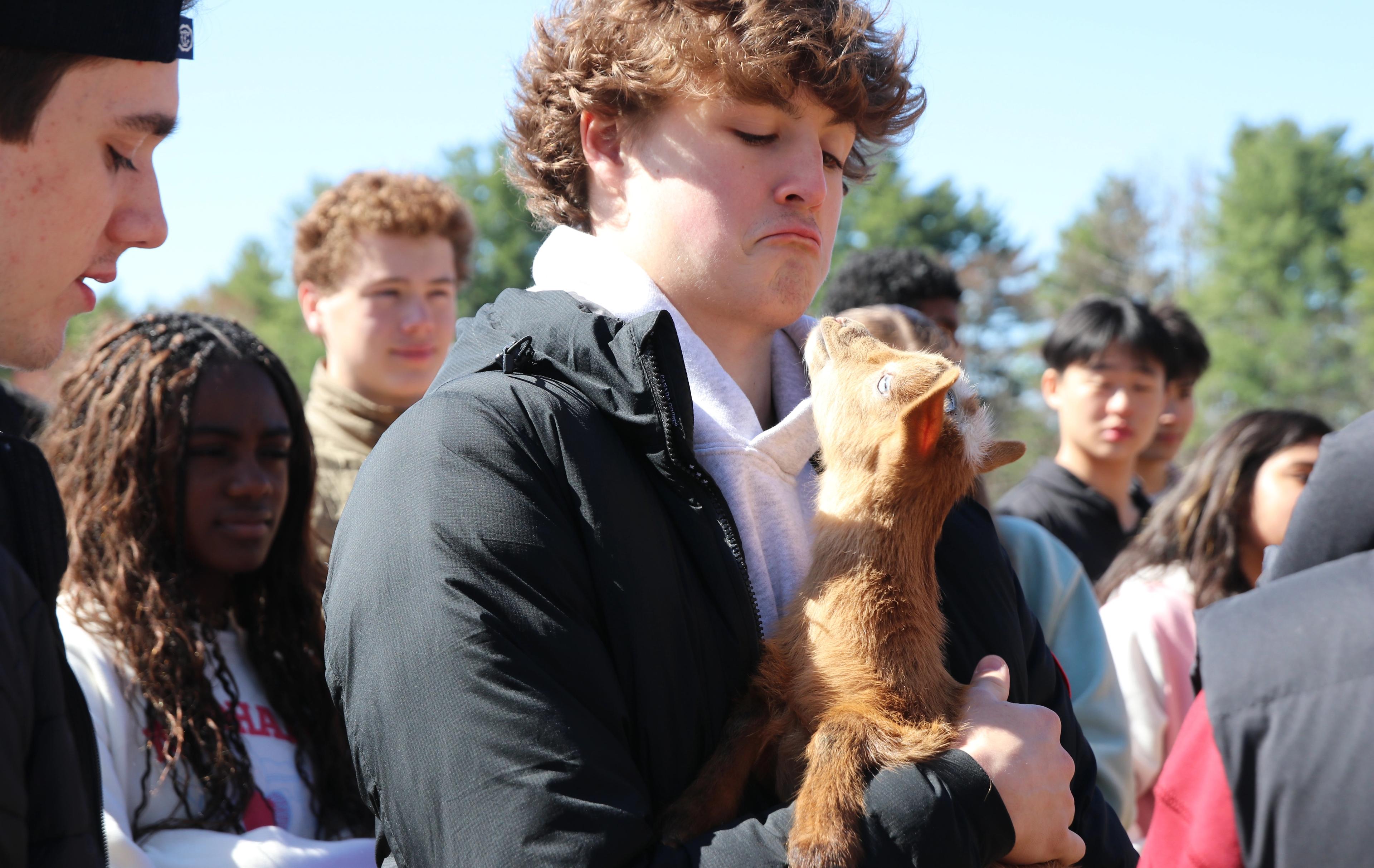 Student holds baby goat