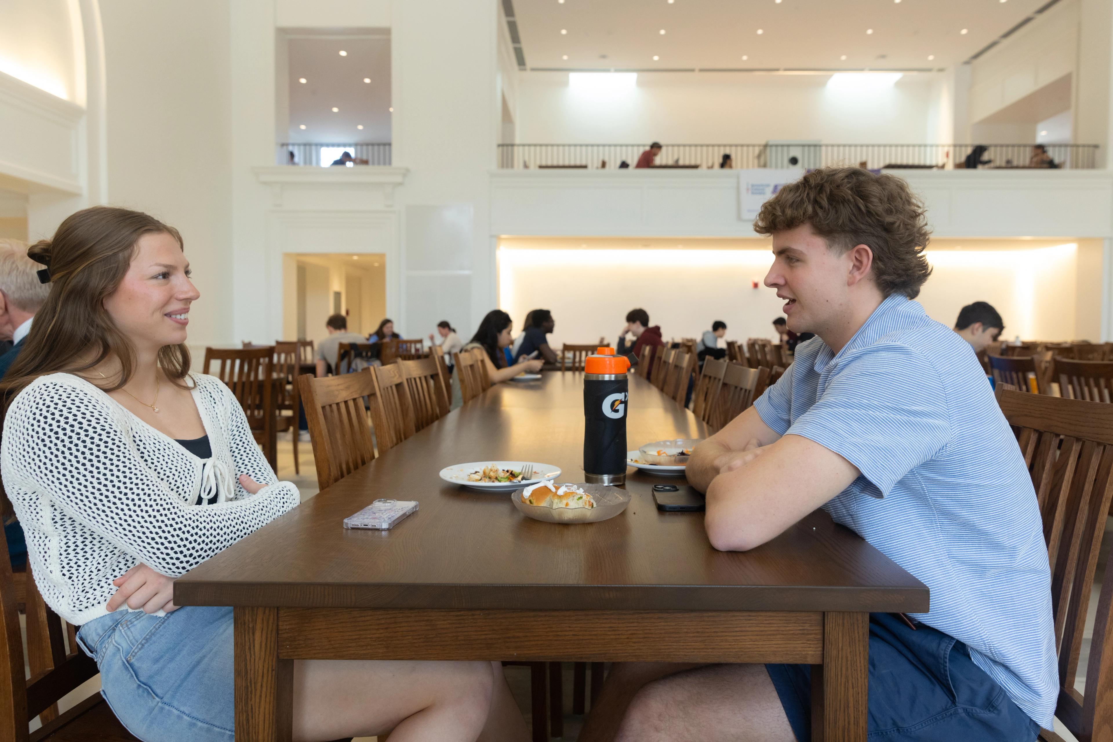 two students eating at a table