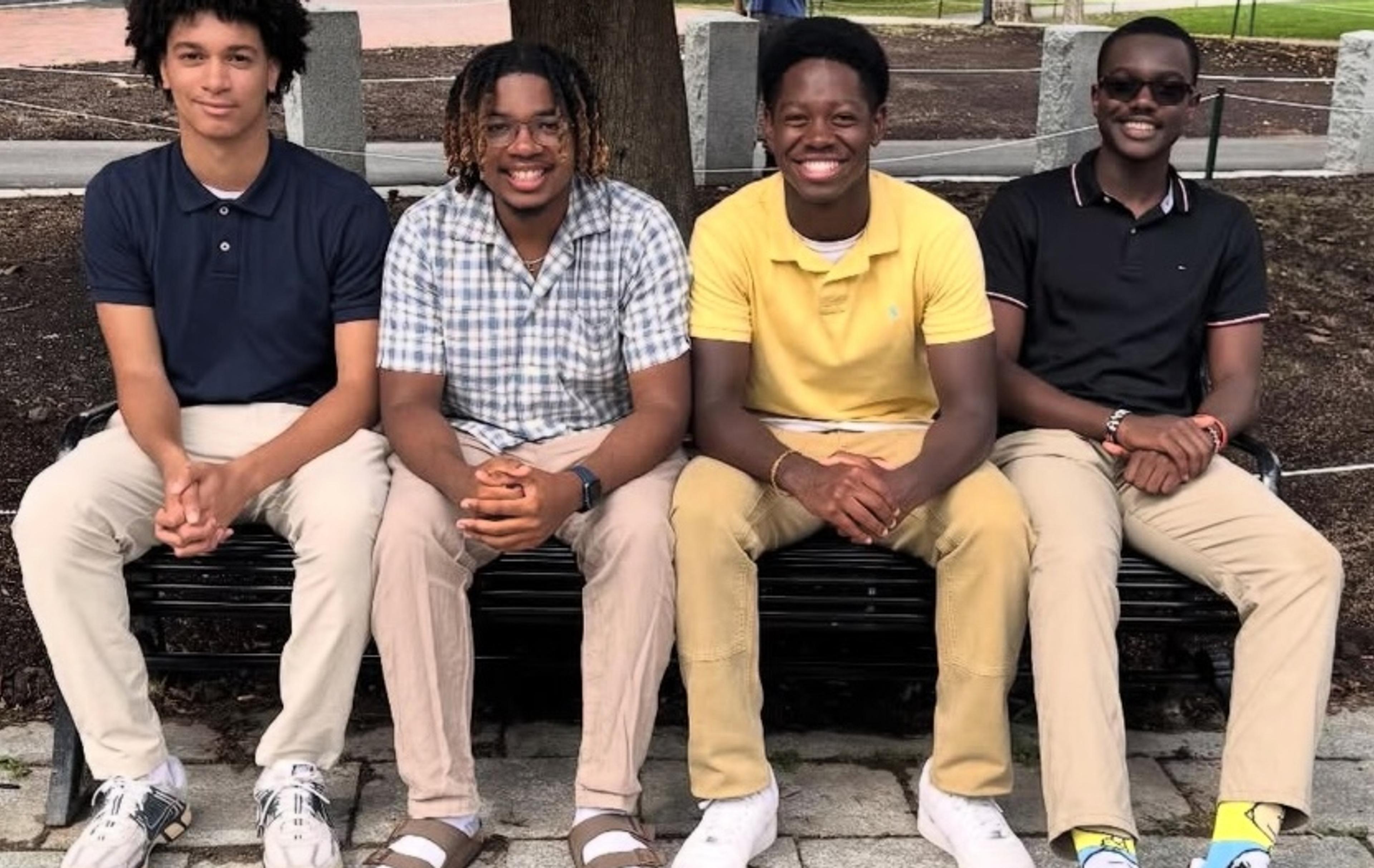 A group of for students sitting on bench