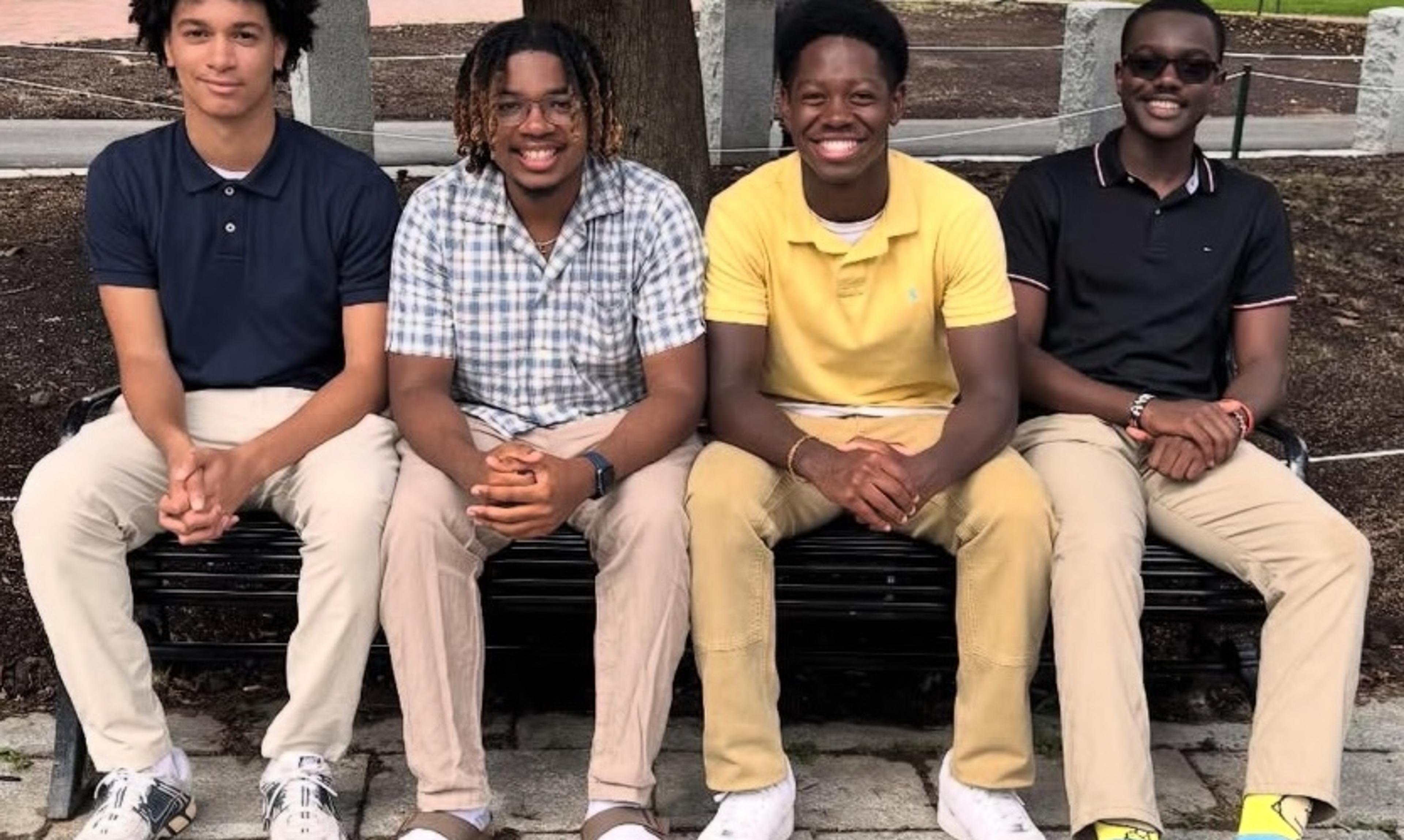 A group of for students sitting on bench
