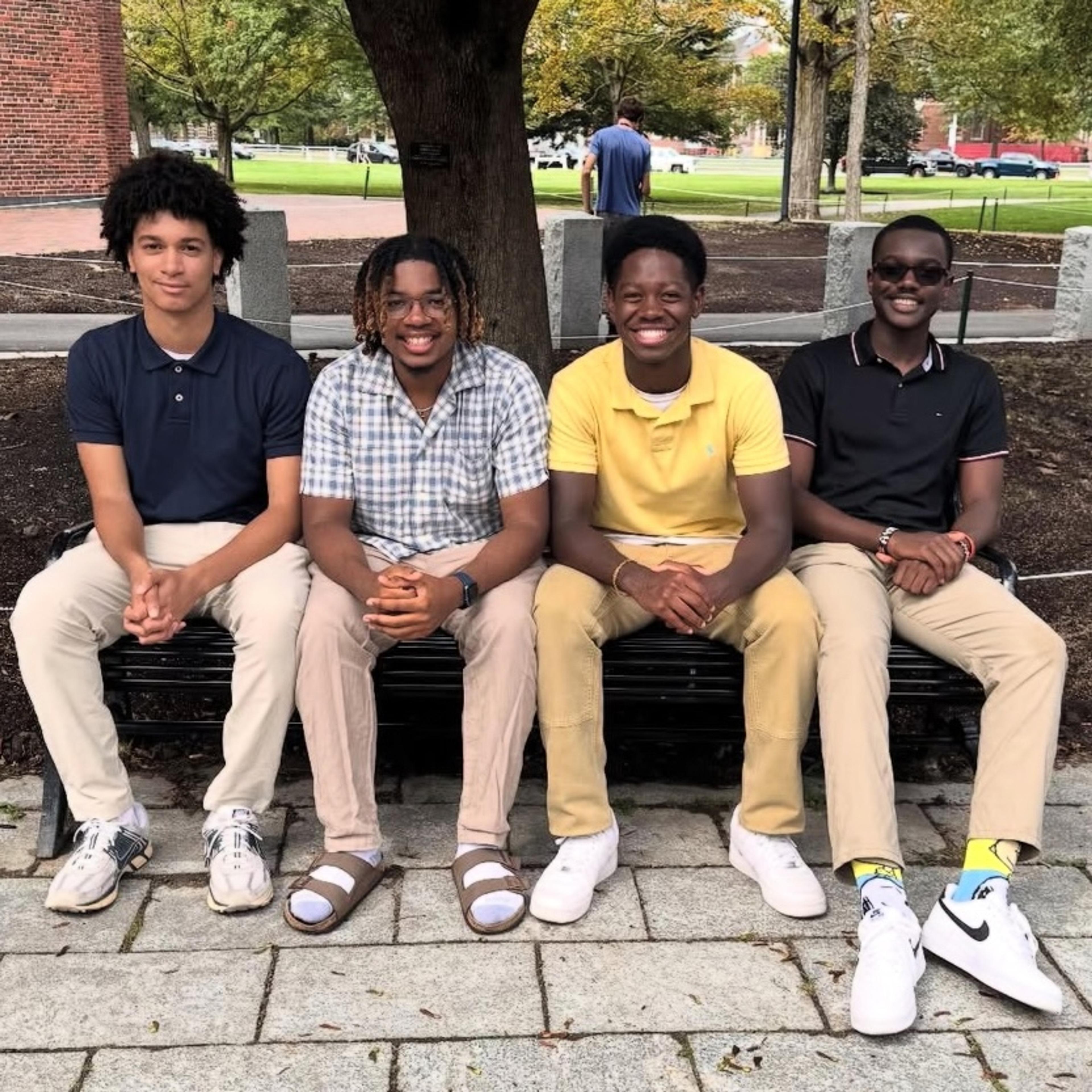 A group of for students sitting on bench