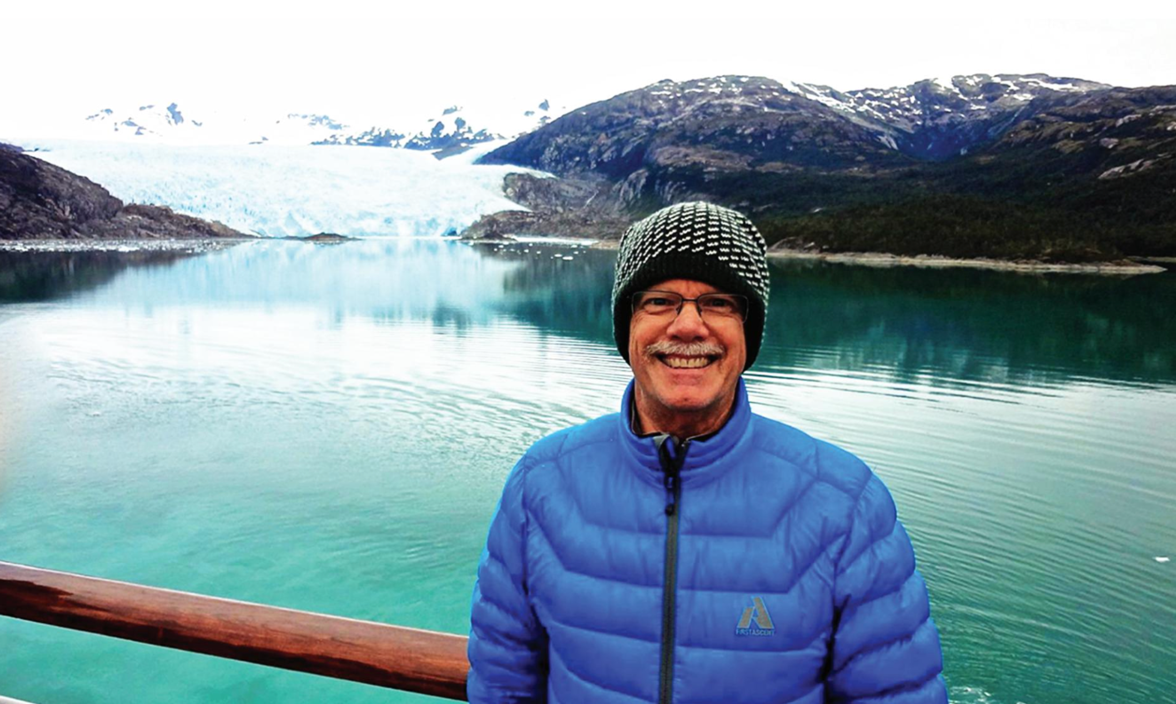 man standing in front of lake