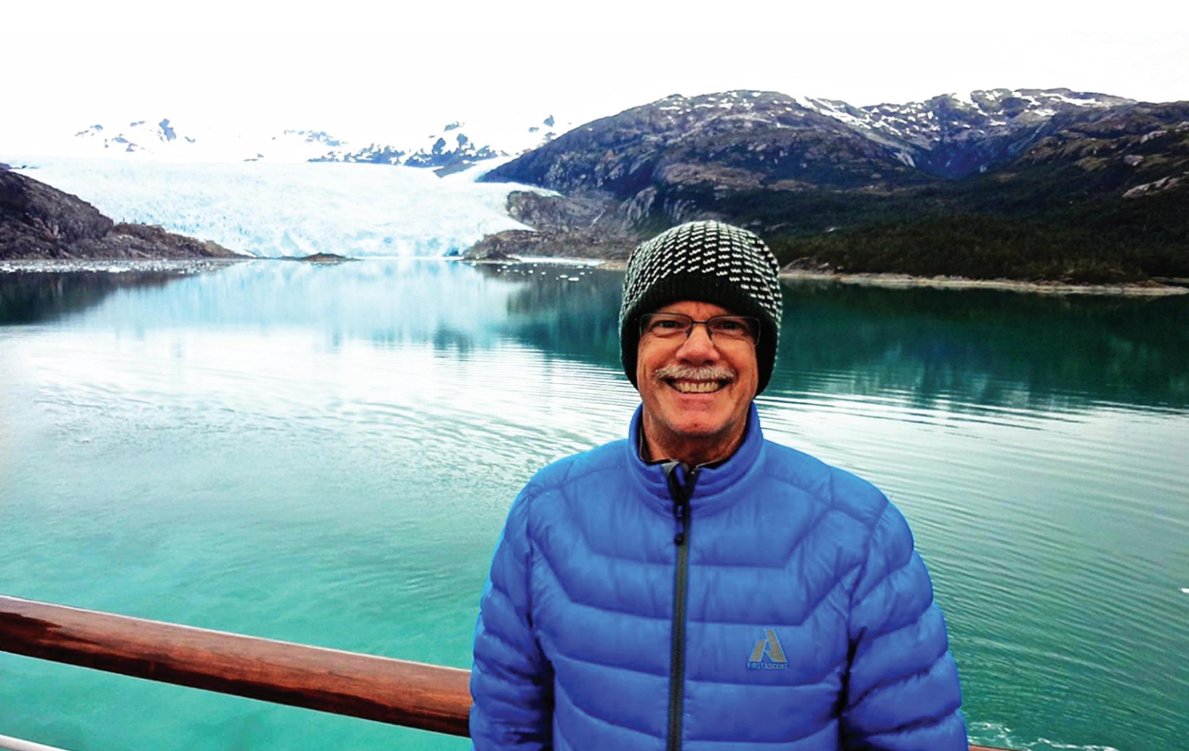 man standing in front of lake