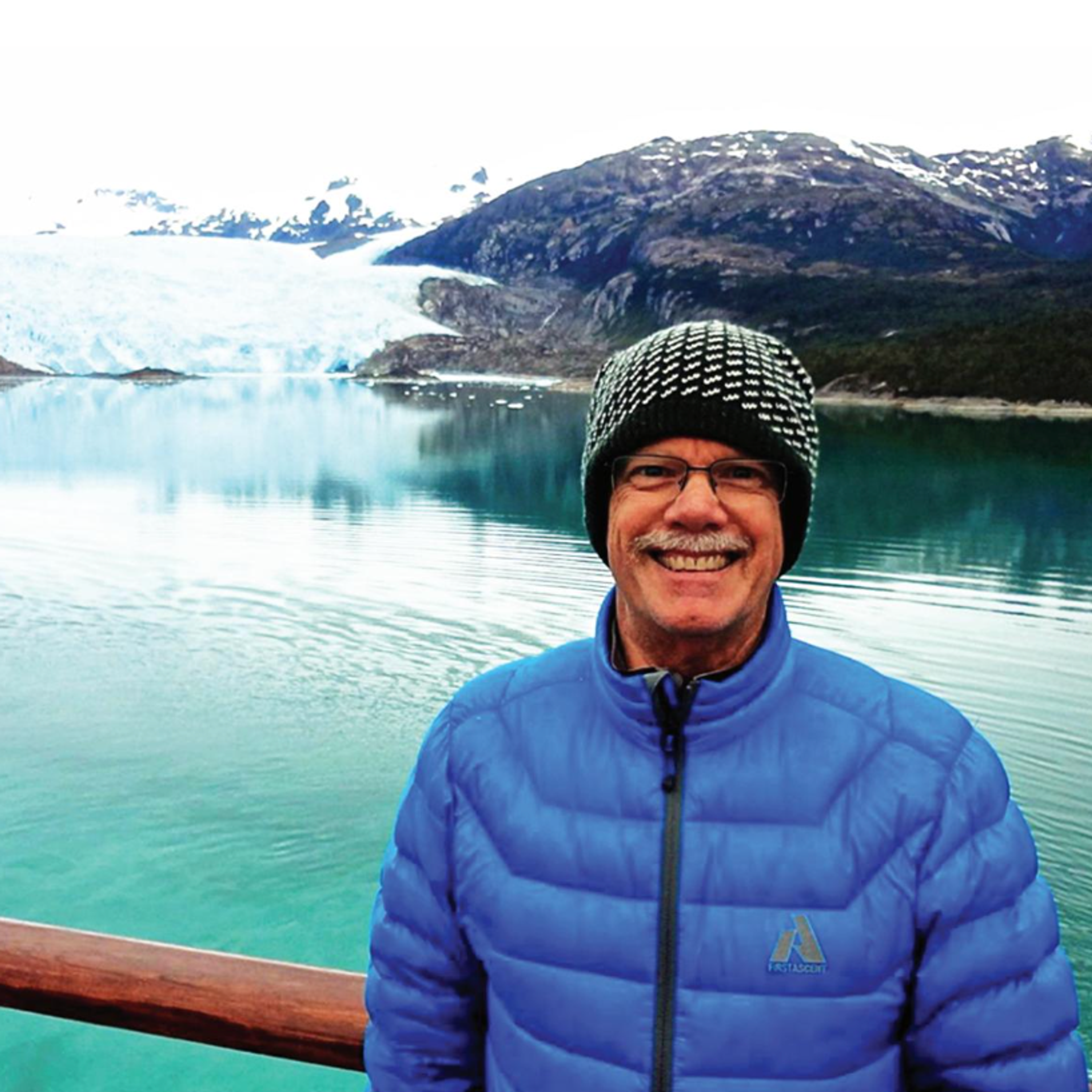 man standing in front of lake