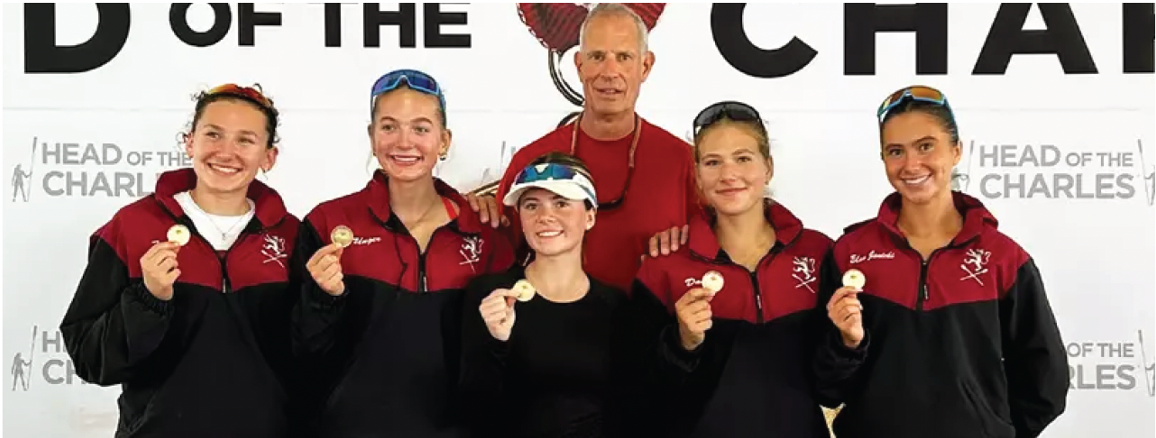 team posing with medal