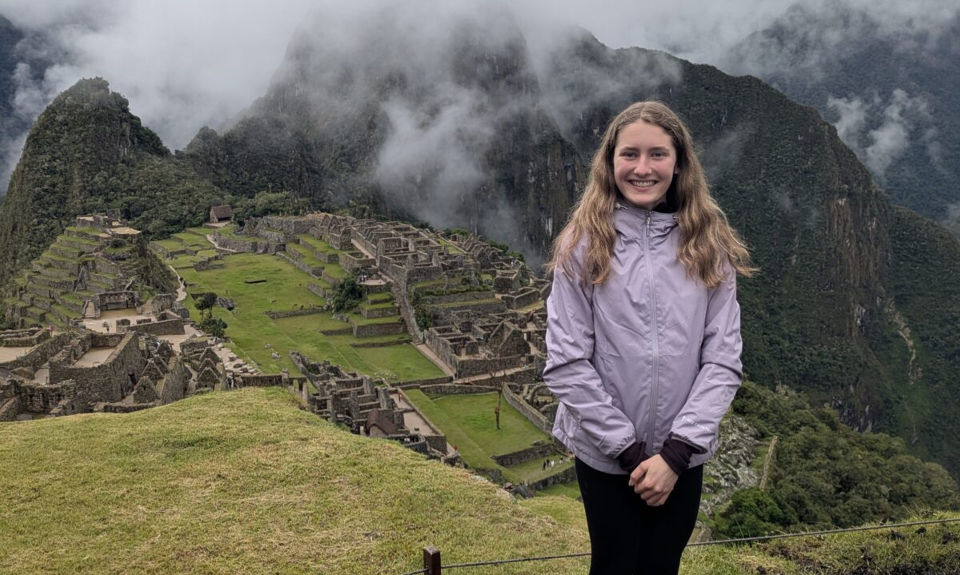Girl stands at Machu Picchu