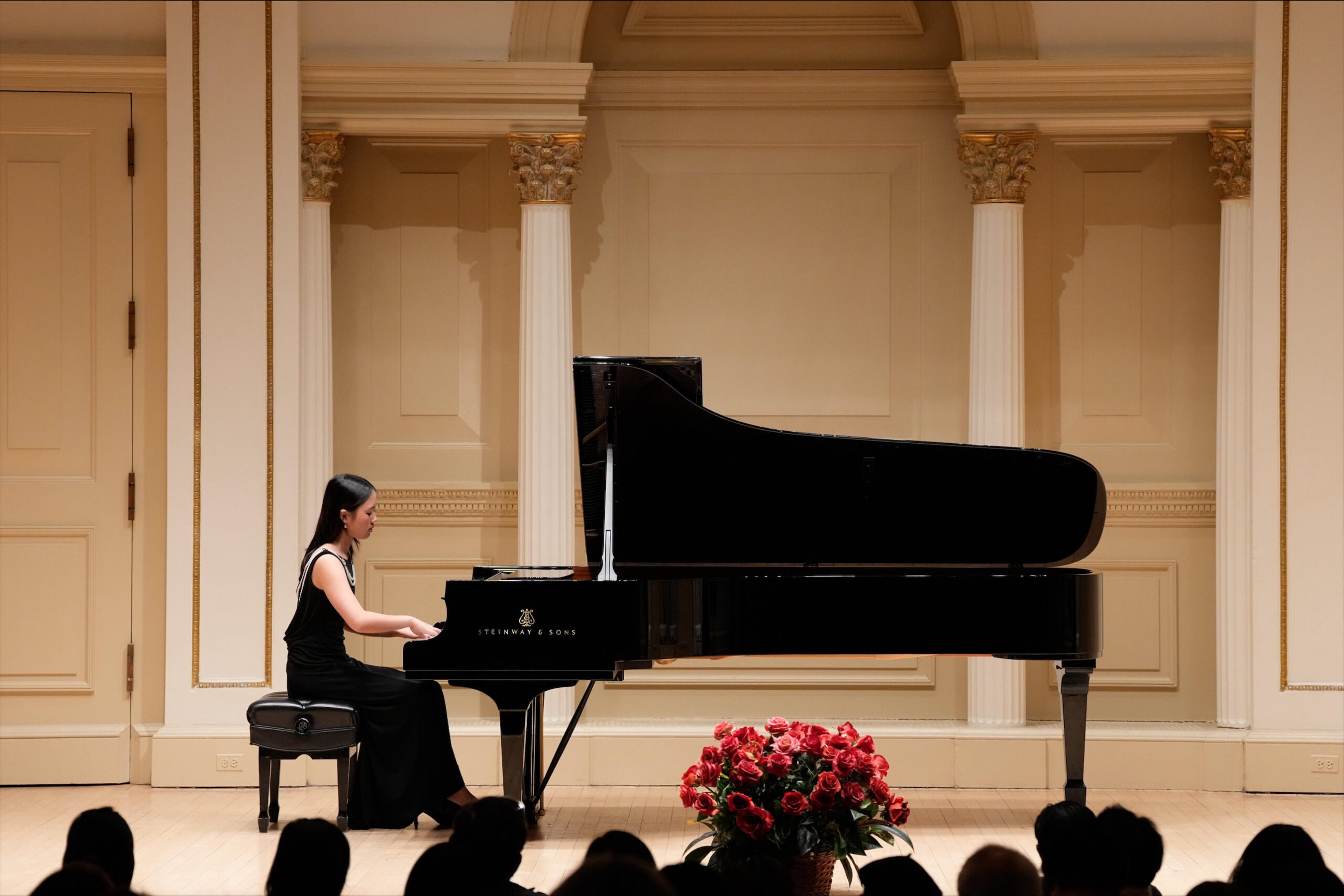 girl plays a grand piano.