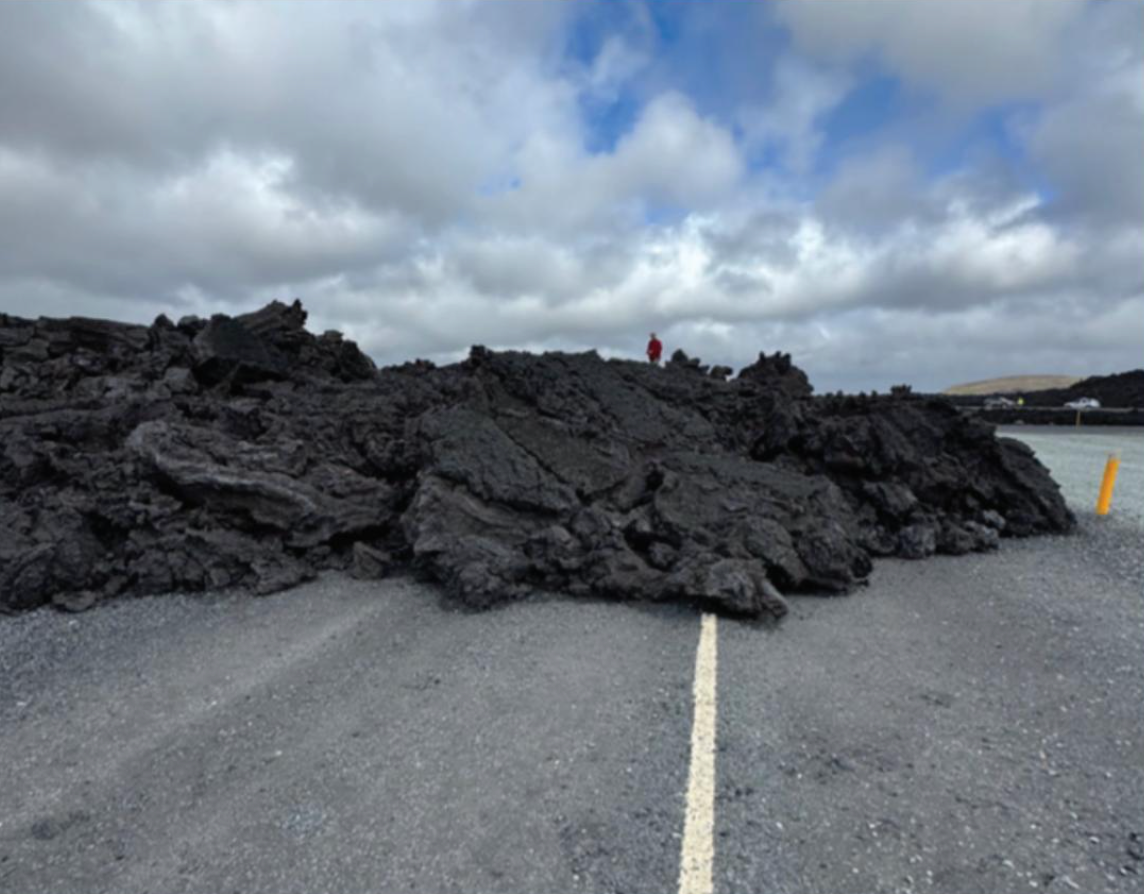 Lava flow from a recent eruption blocks the road.