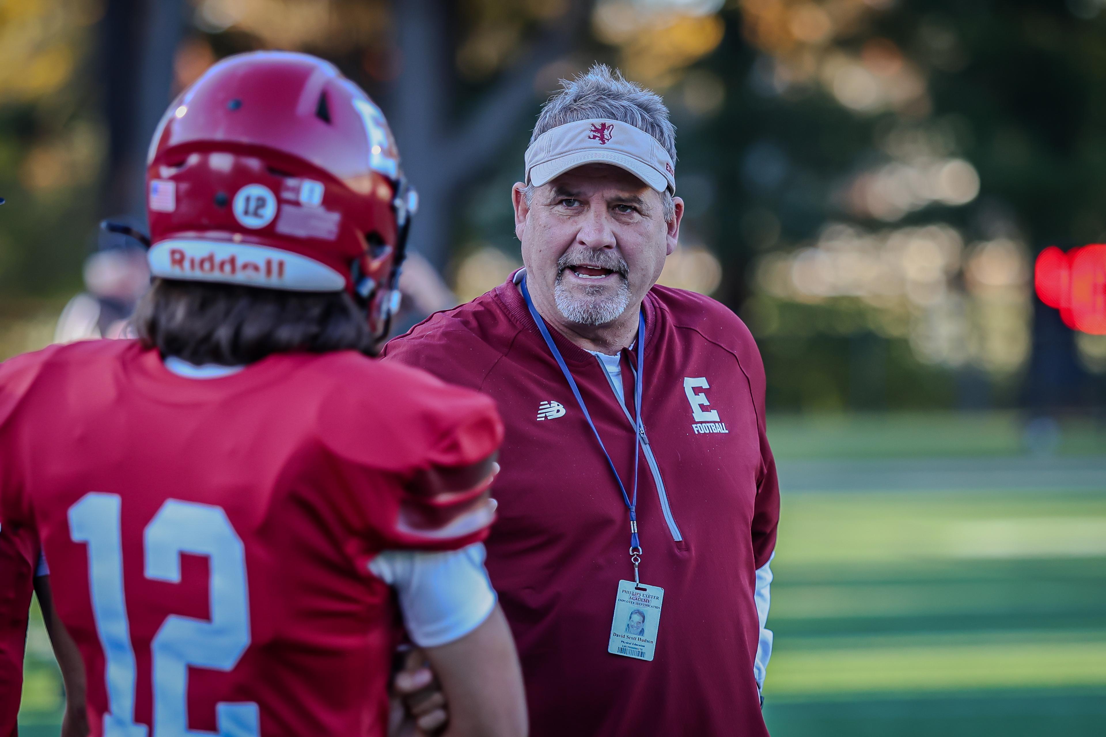 A coach speaks to a player.