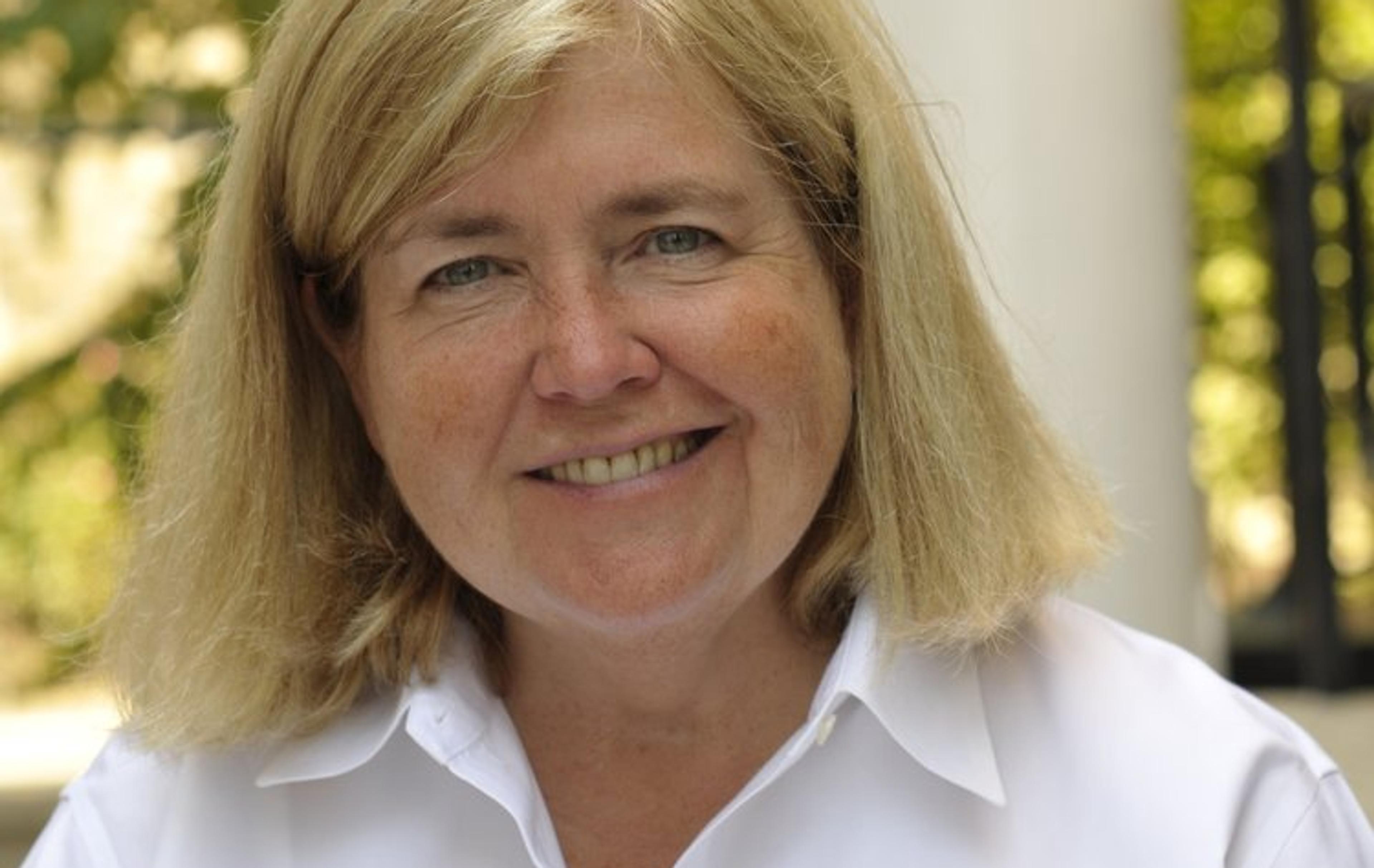 Woman in white shirt smiles