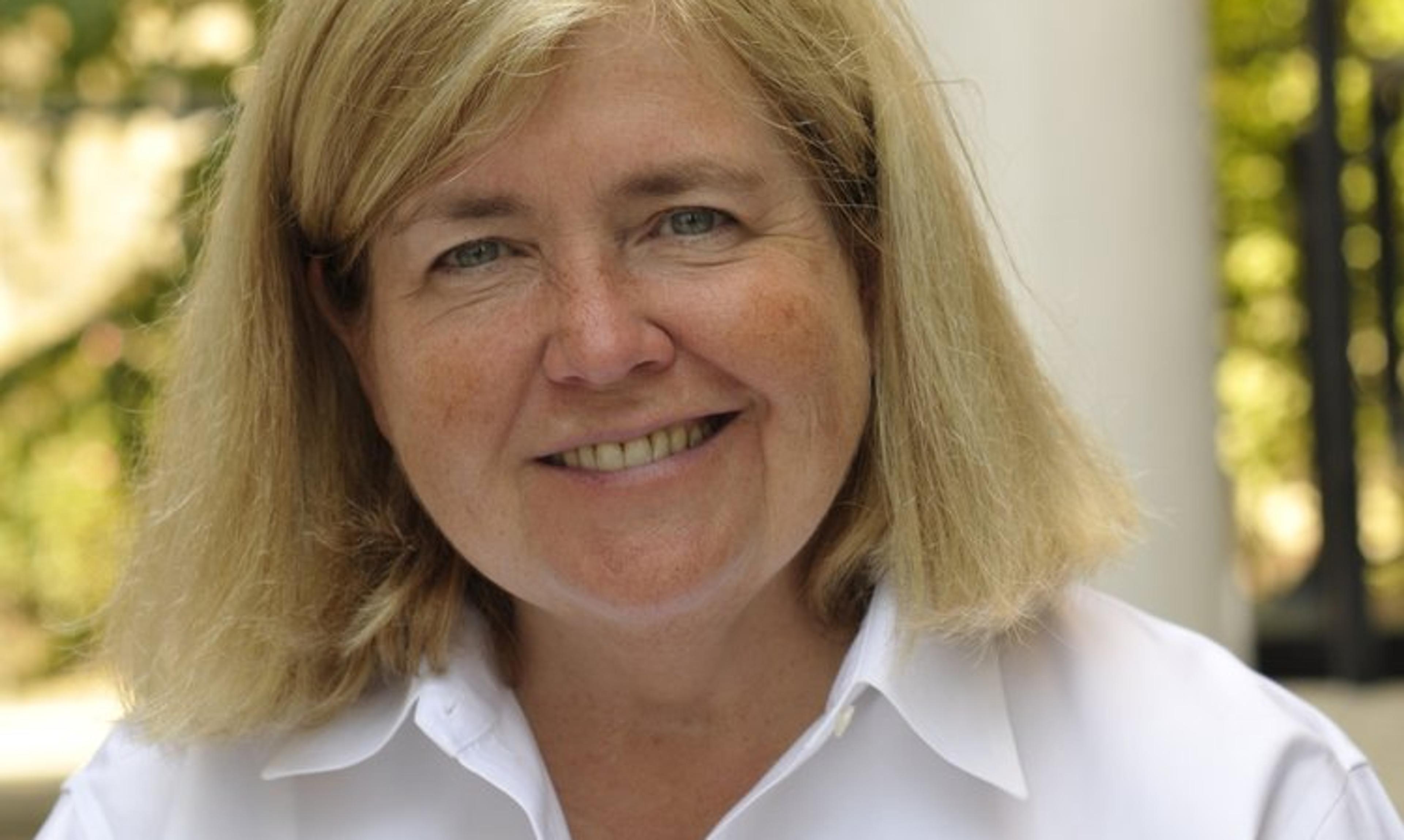 Woman in white shirt smiles