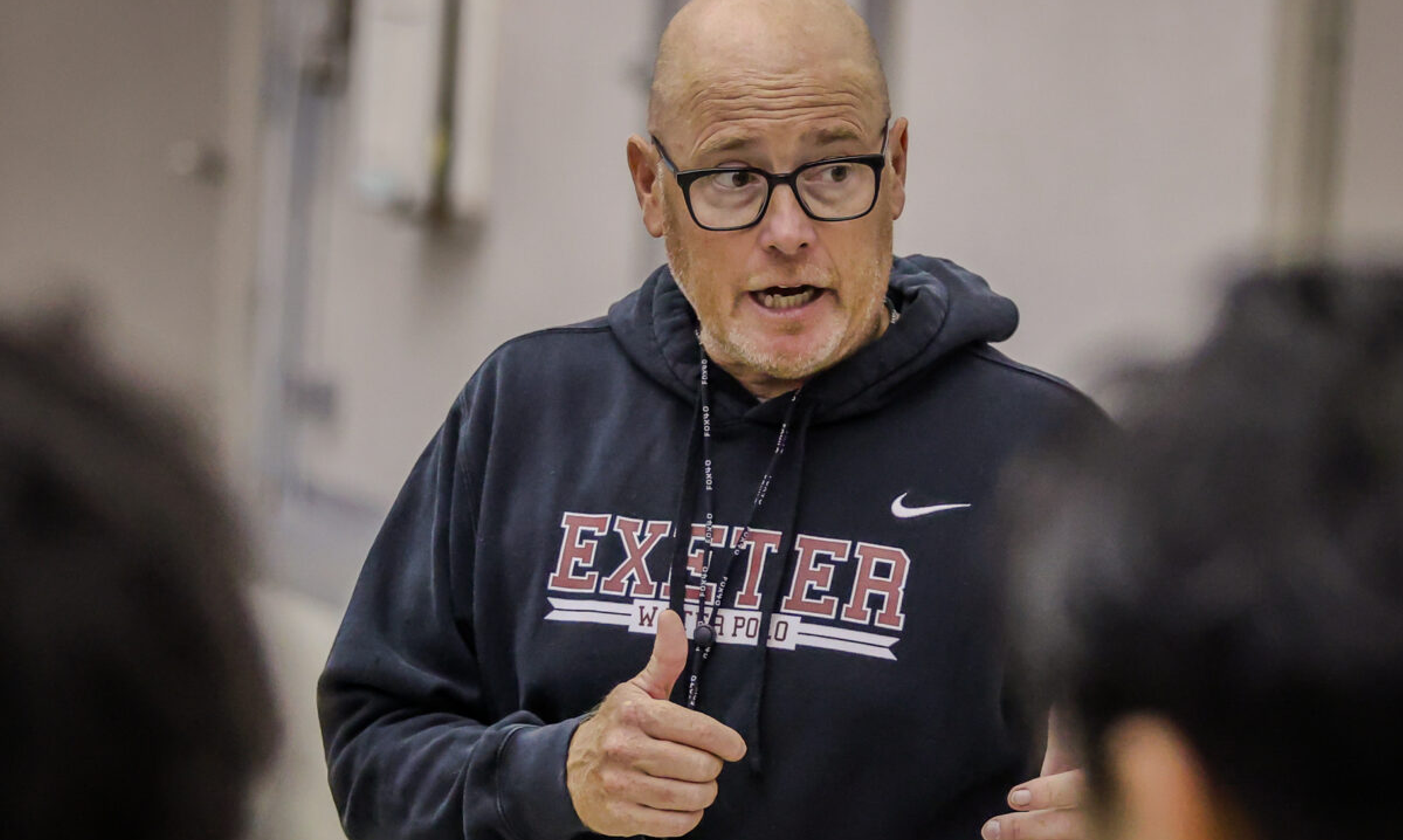Coach talking to students in classroom
