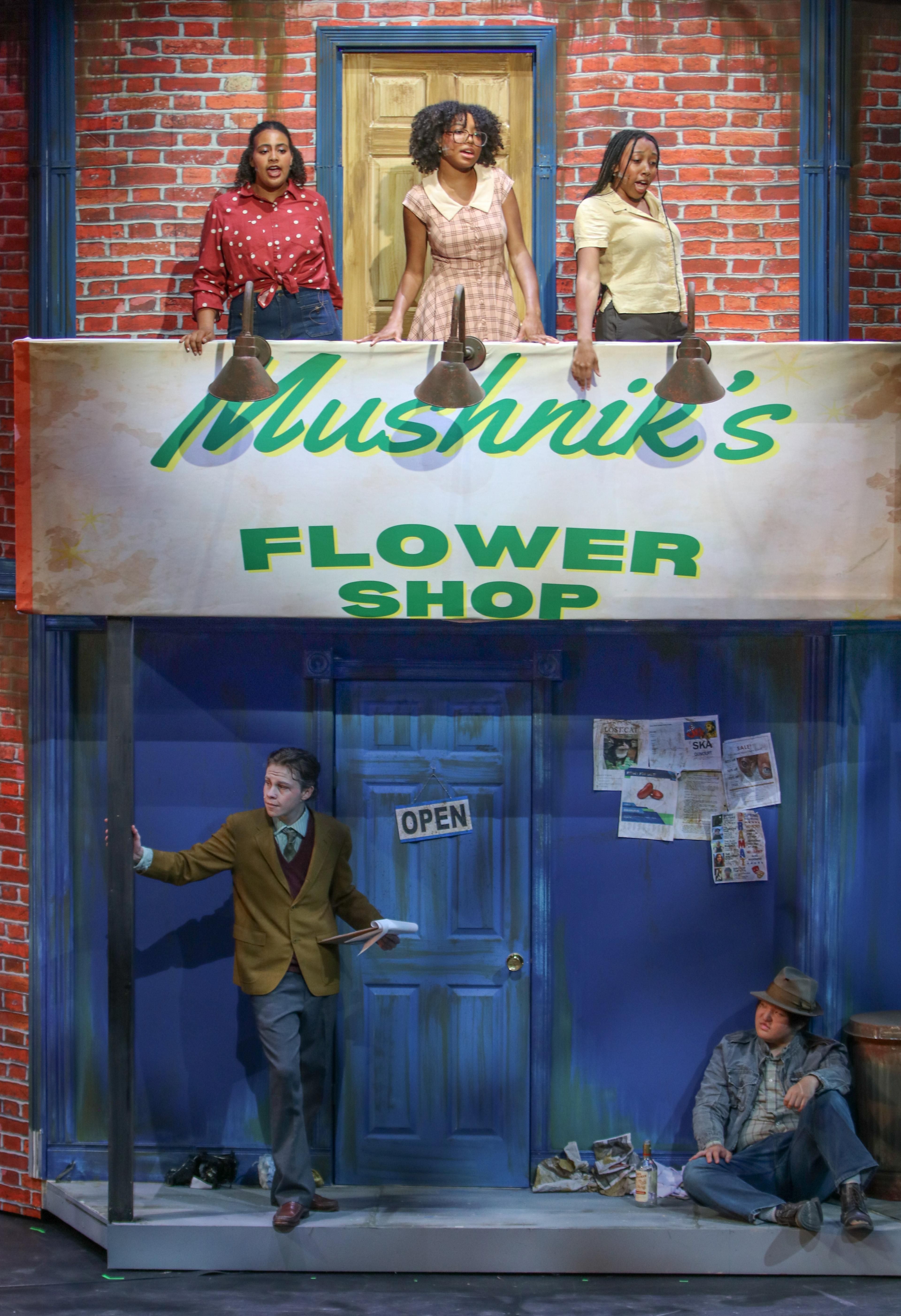 Student actors stand on Goel Theater and Dance Main Stage
