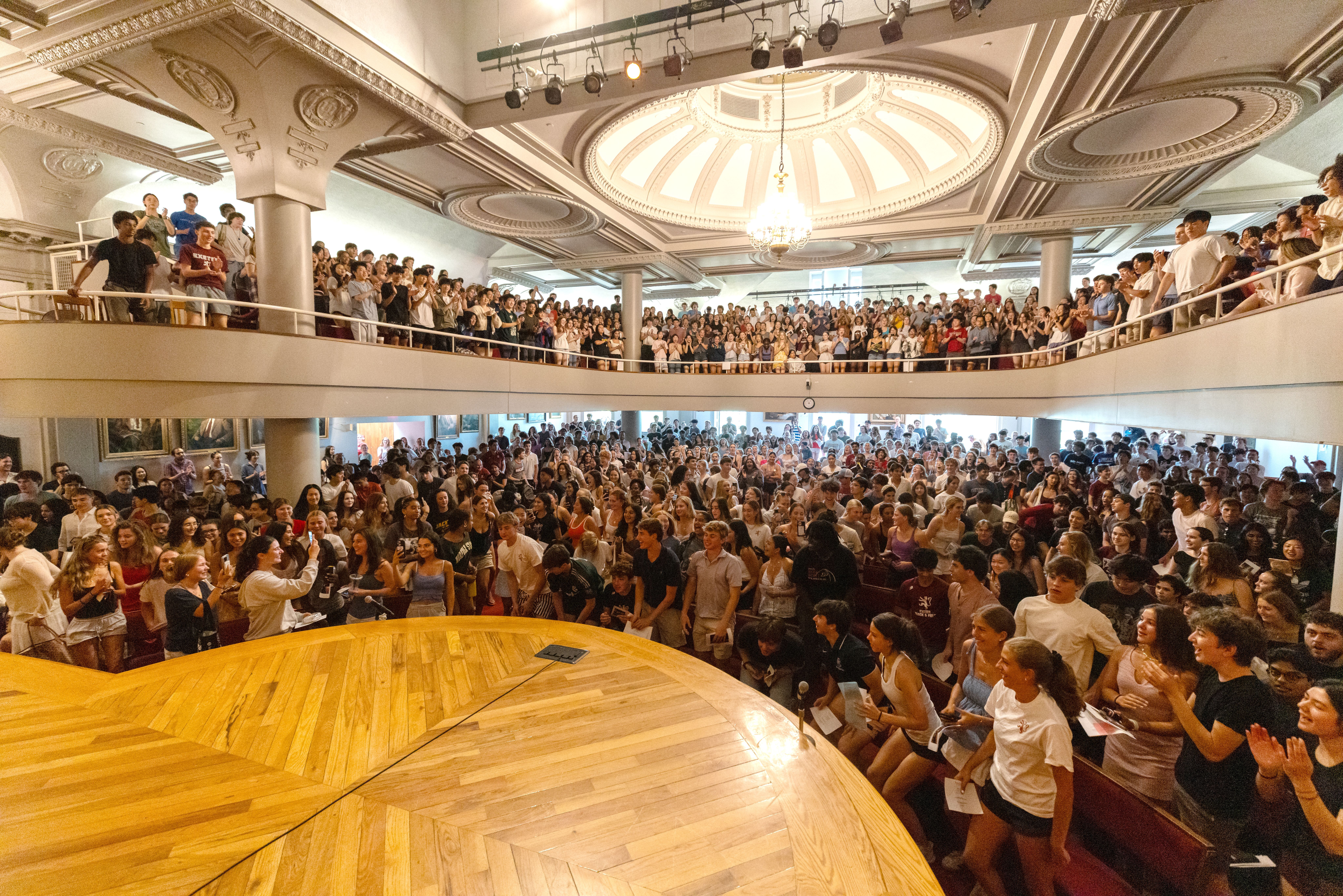 people gathering in assembly hall
