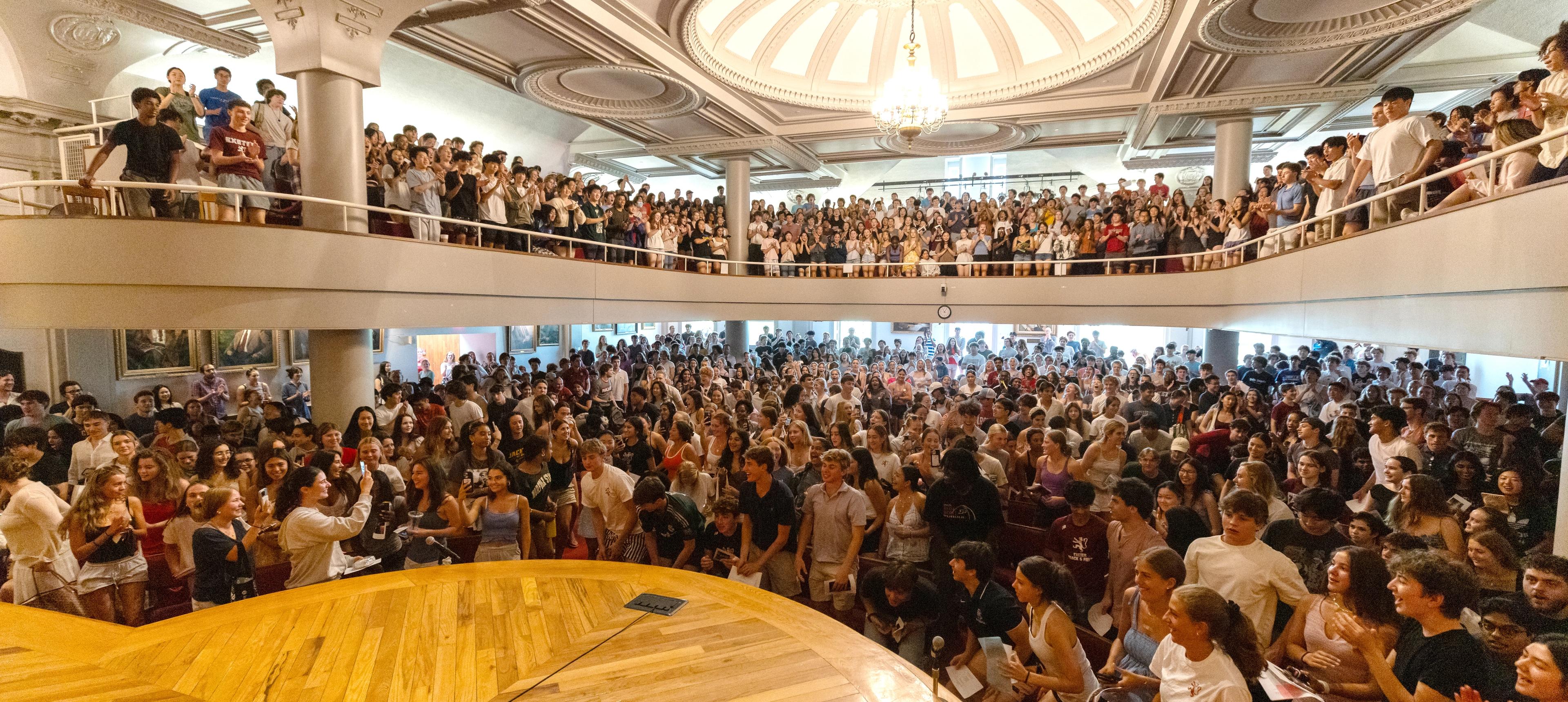 people gathering in assembly hall
