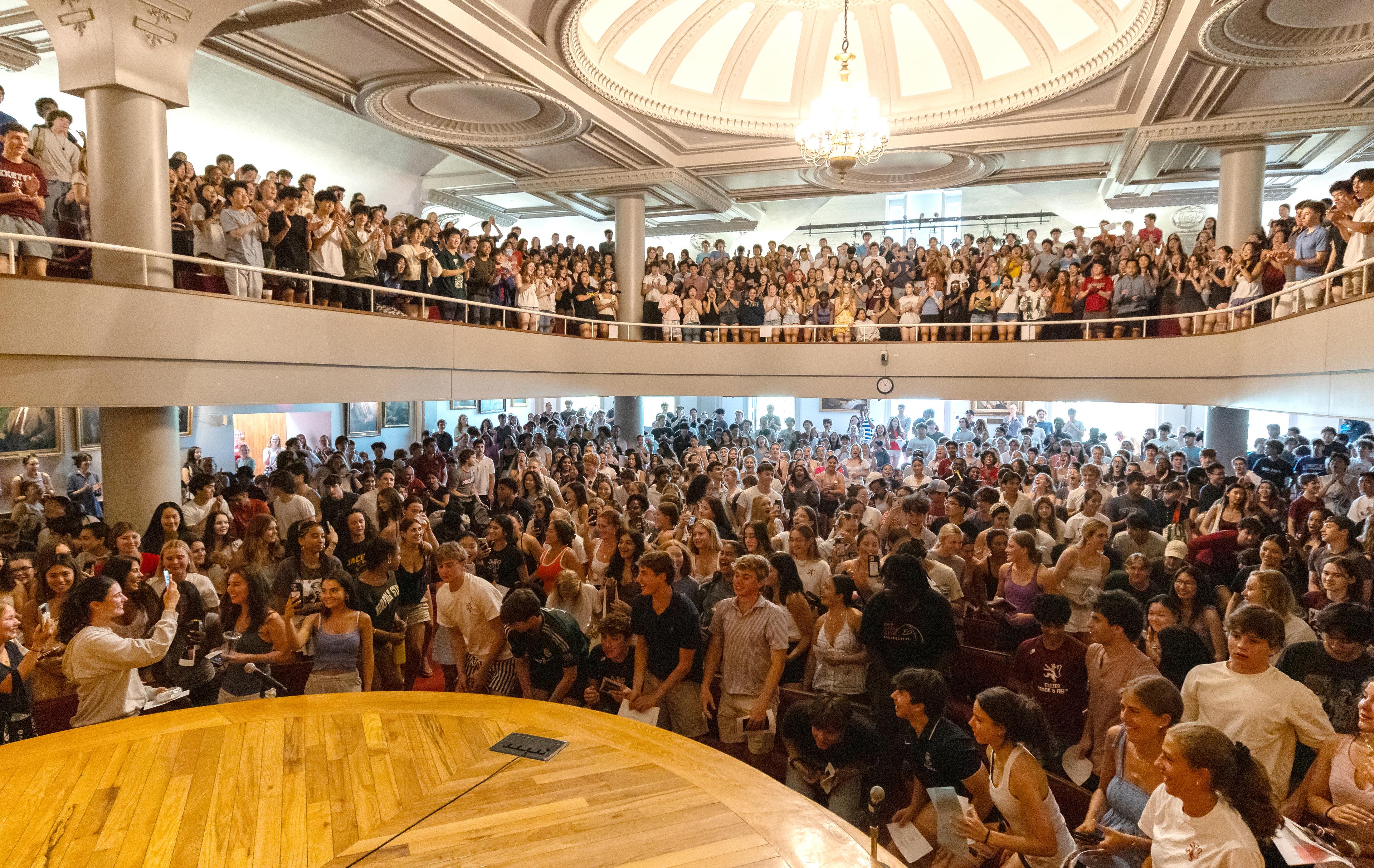 people gathering in assembly hall