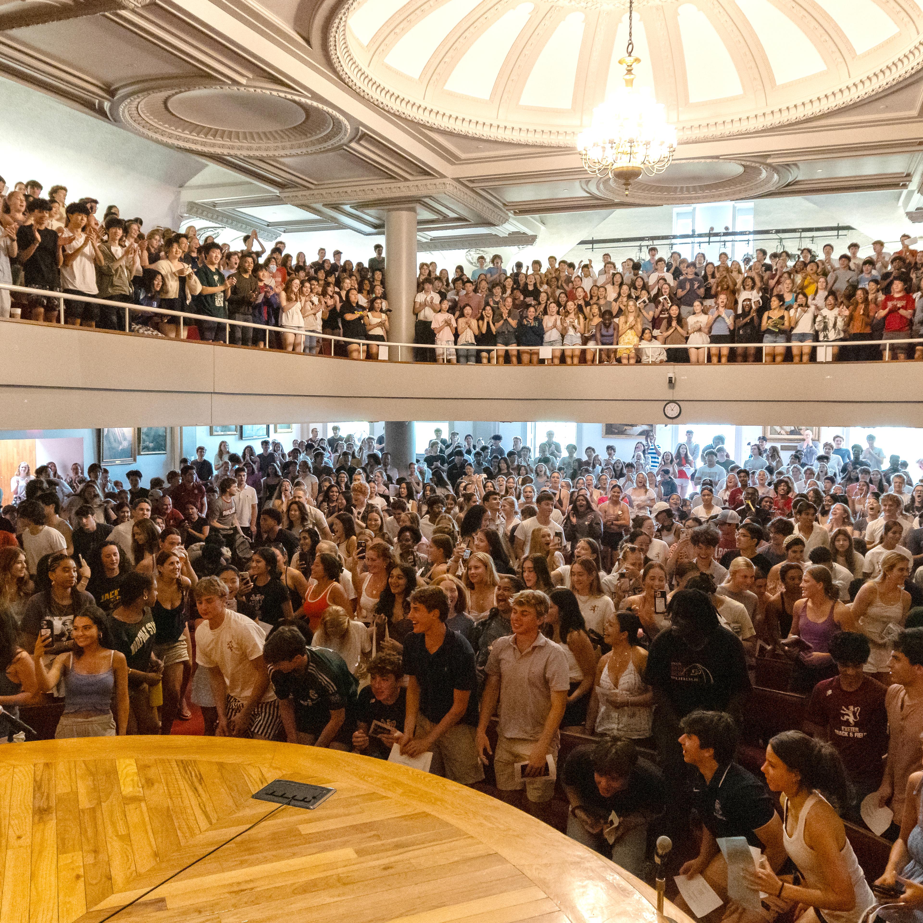 people gathering in assembly hall