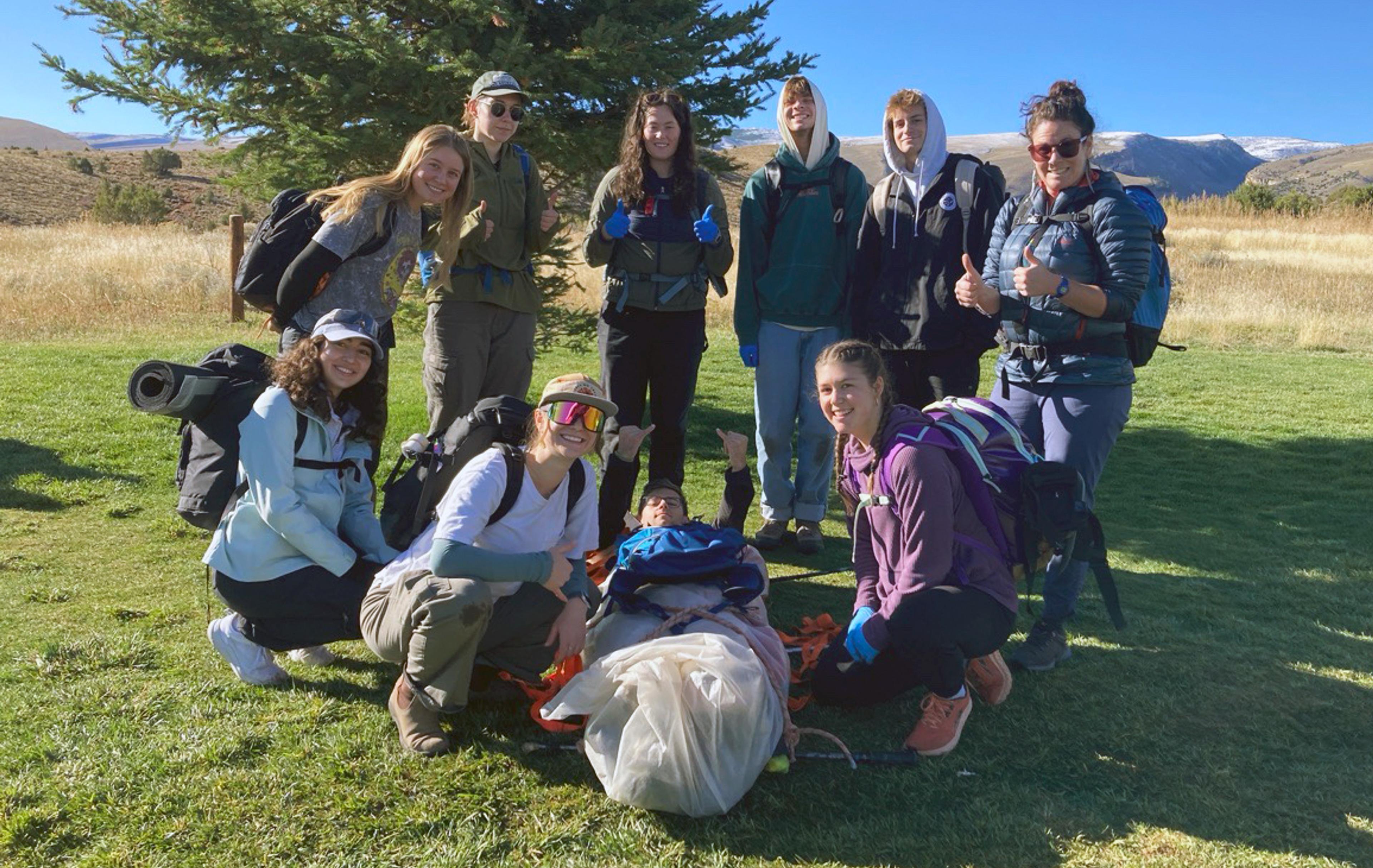 Group standing outside with hiking equipment