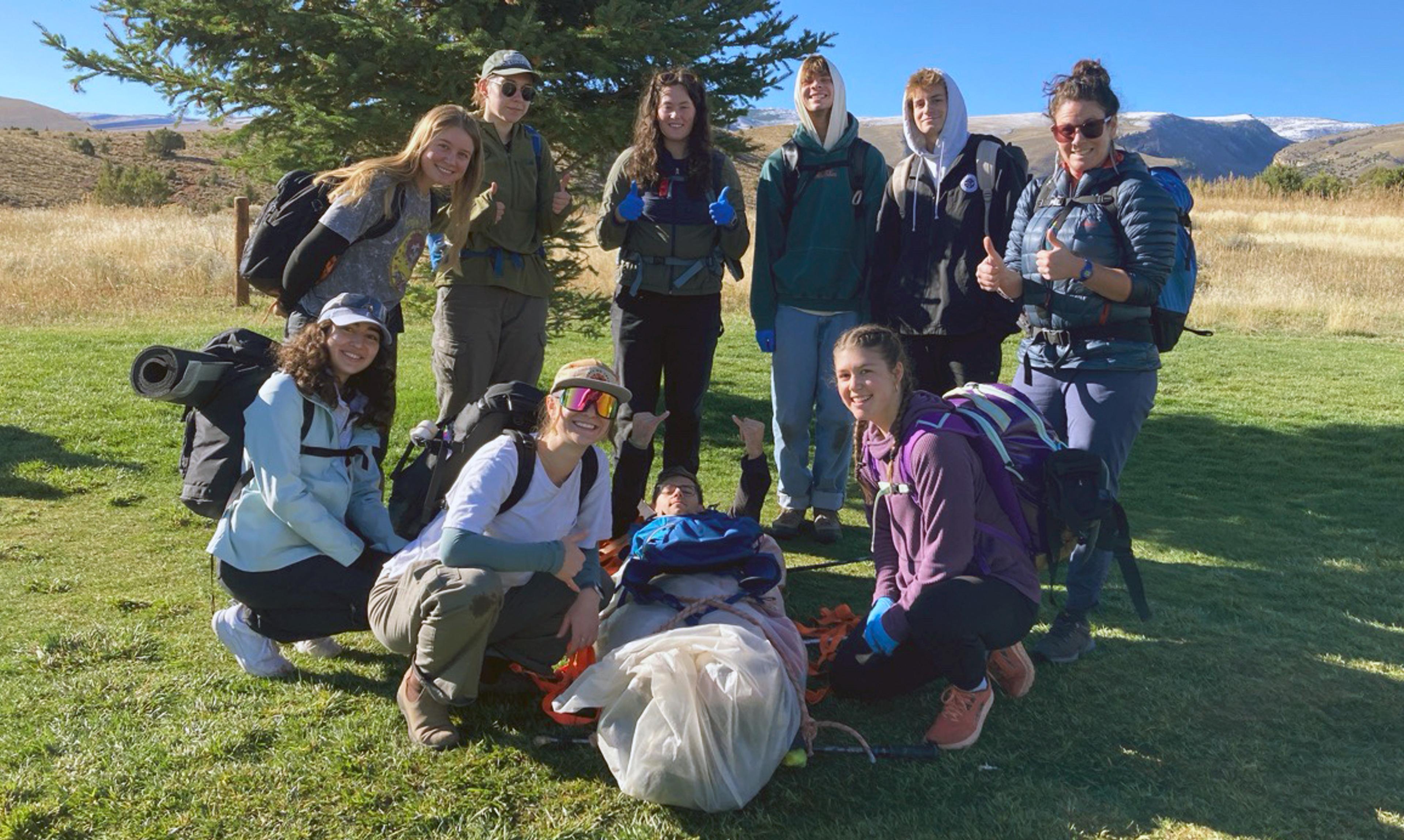 Group standing outside with hiking equipment