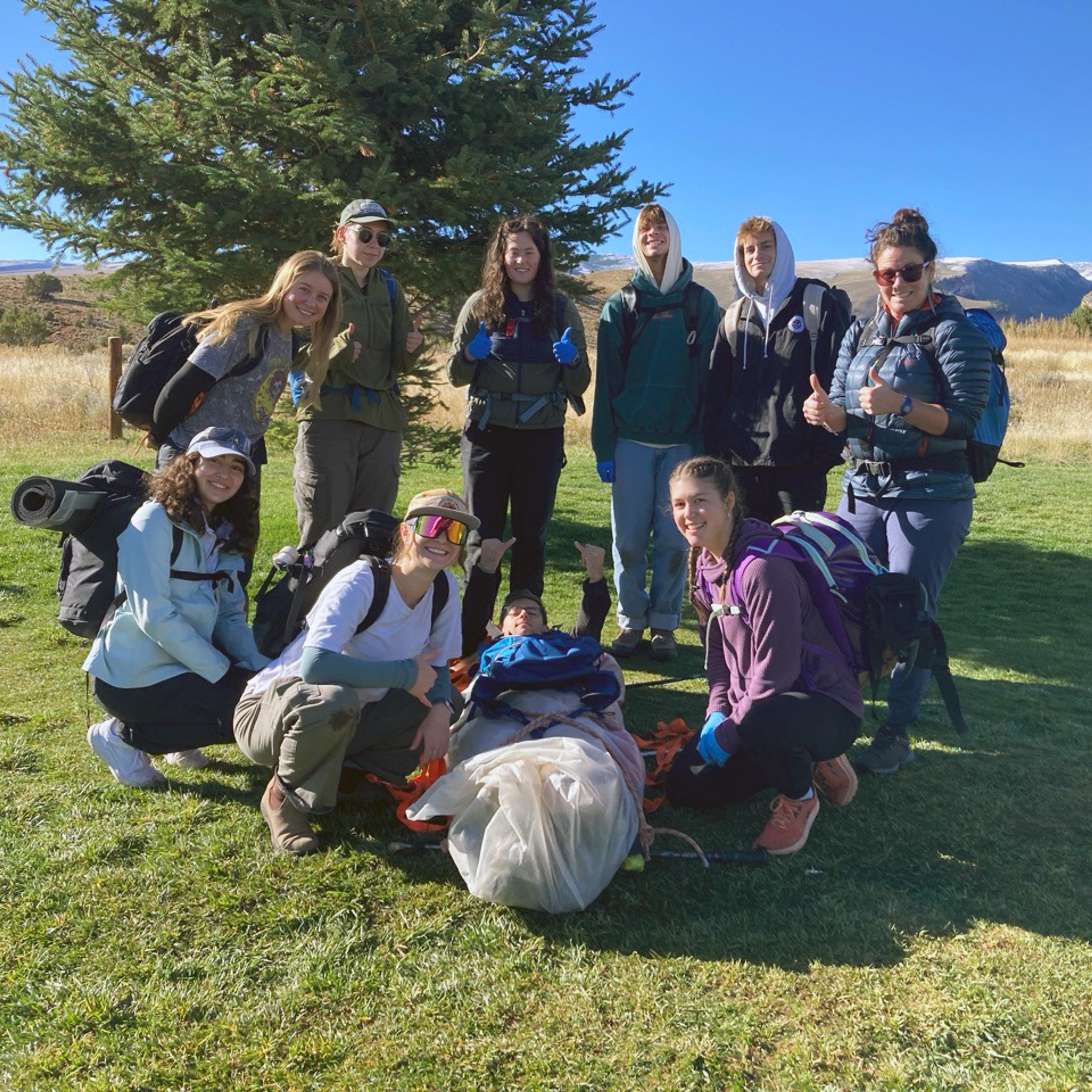 Group standing outside with hiking equipment