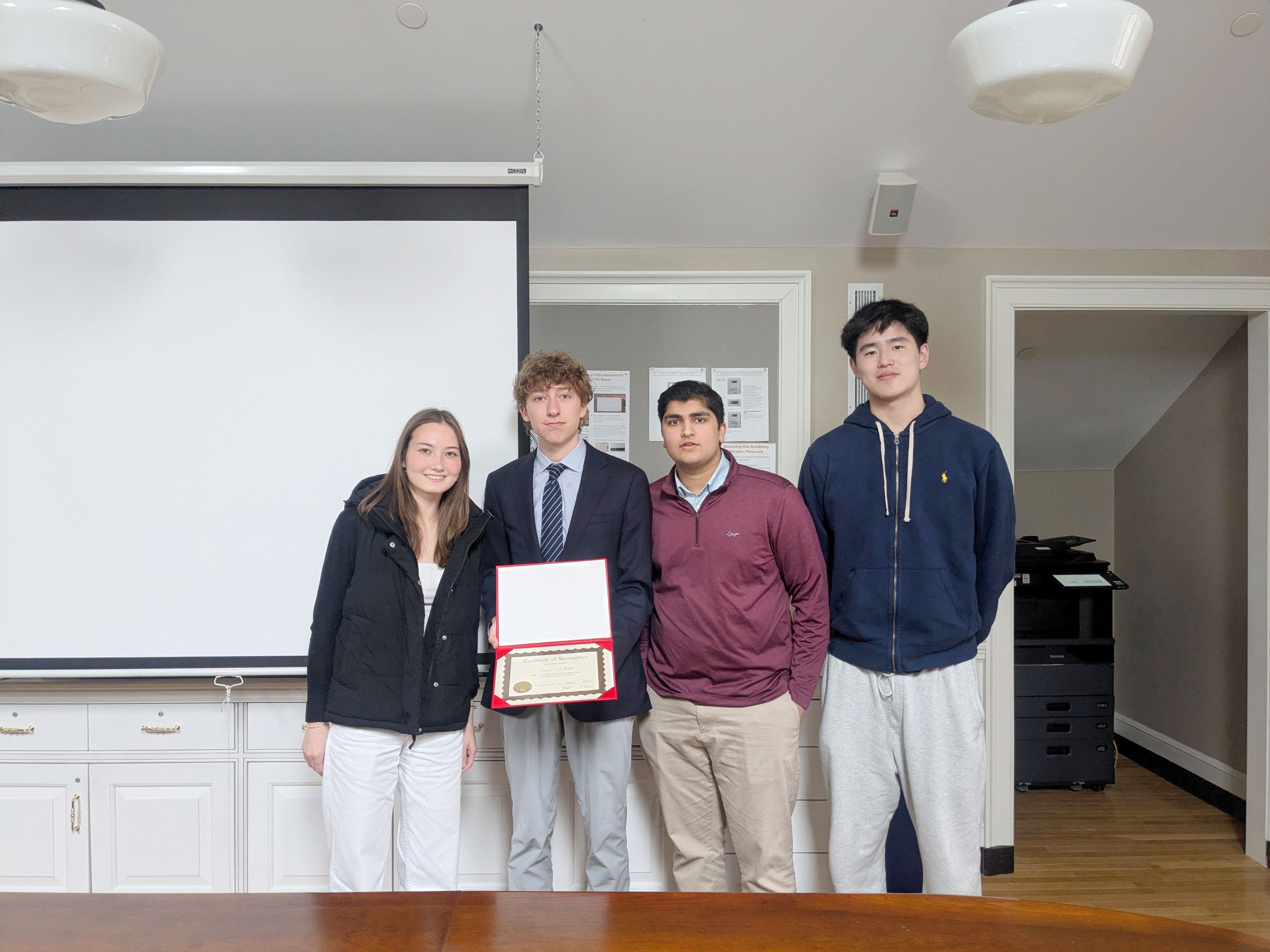 students holding up a certificate