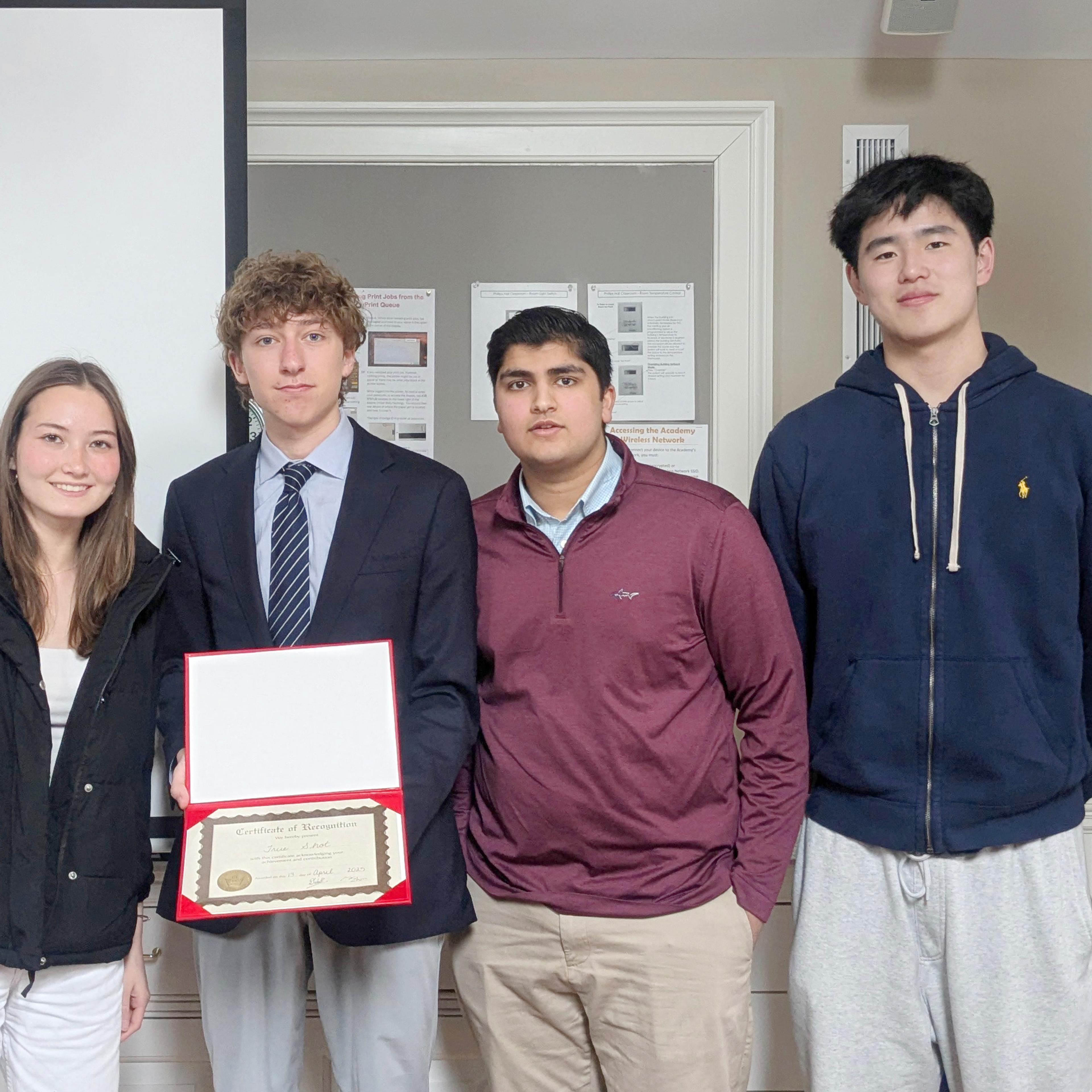 students holding up a certificate