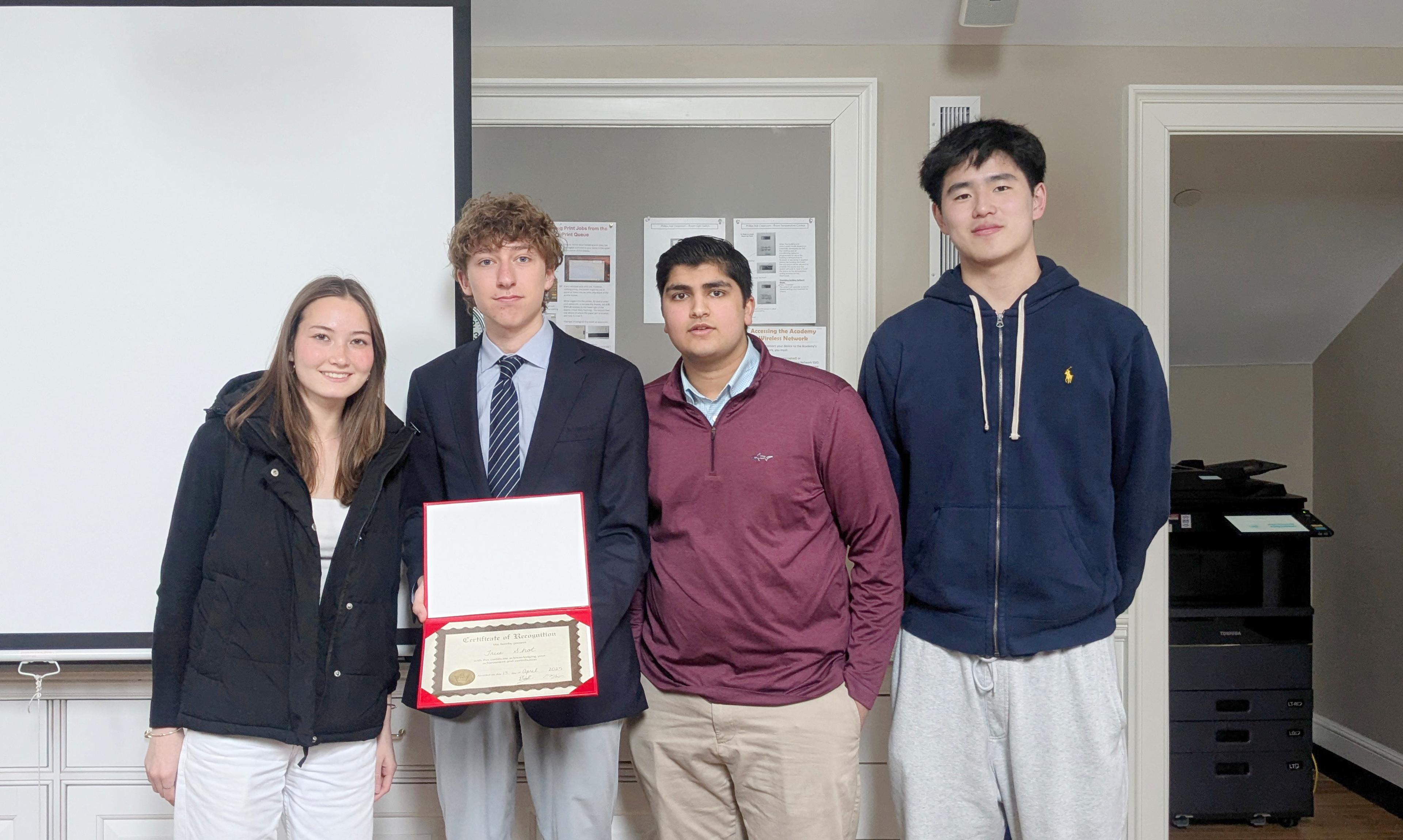 students holding up a certificate