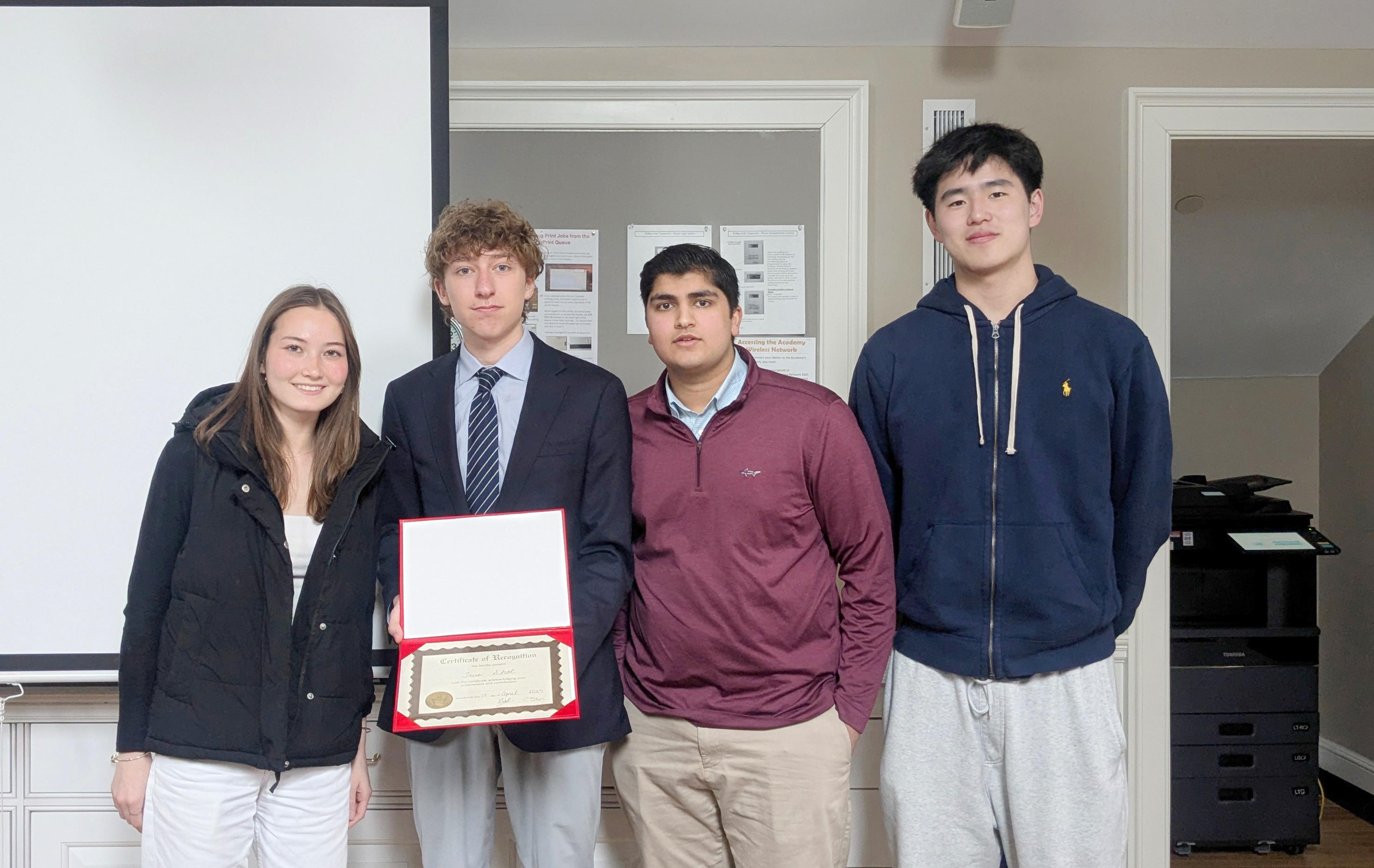 students holding up a certificate